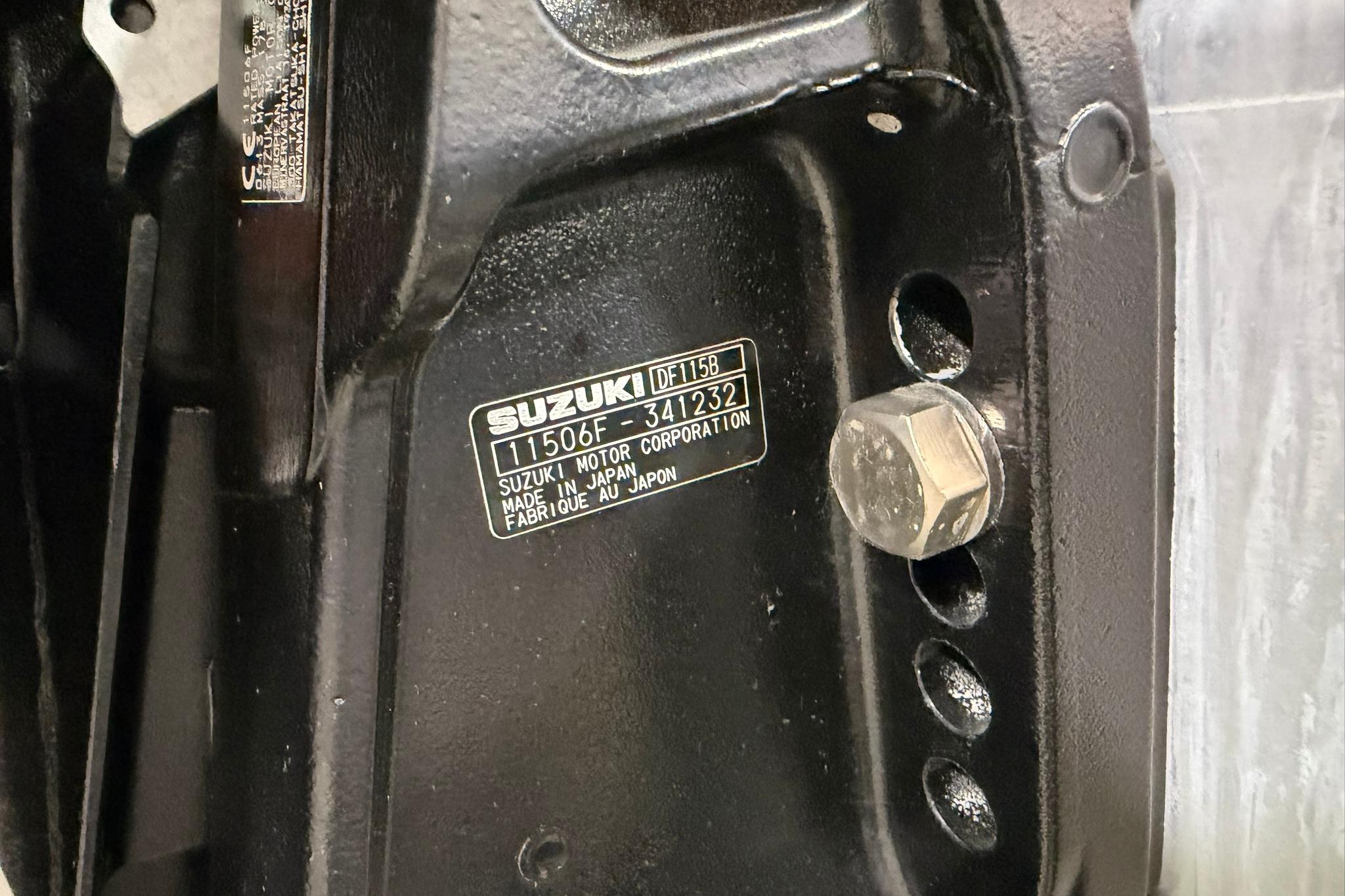 Close-up of a Suzuki motor part with identification plate, 2023 Crest Classic LX 200.