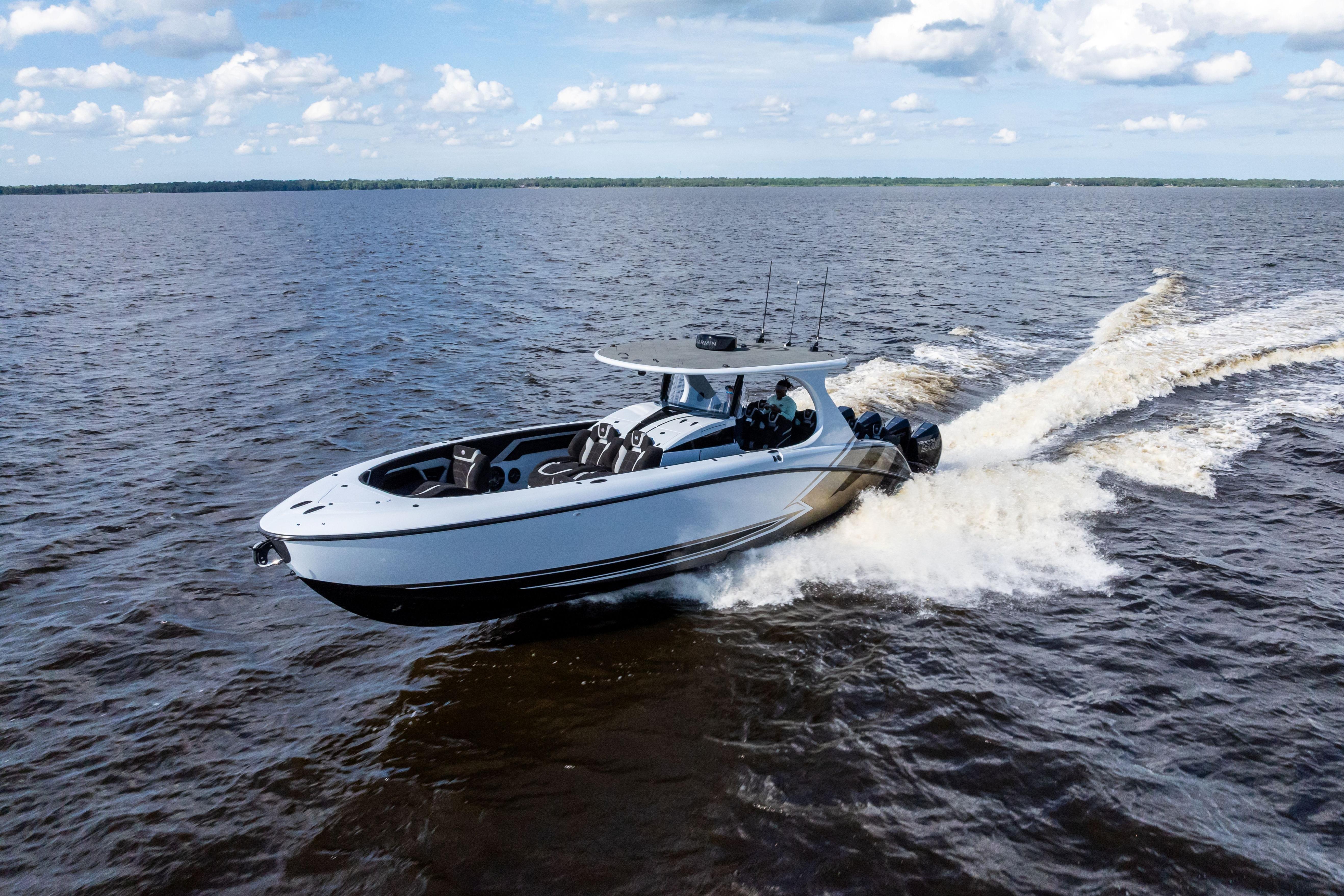 2027 Mystic Powerboats M4200 cruising on open water under a partly cloudy sky.
