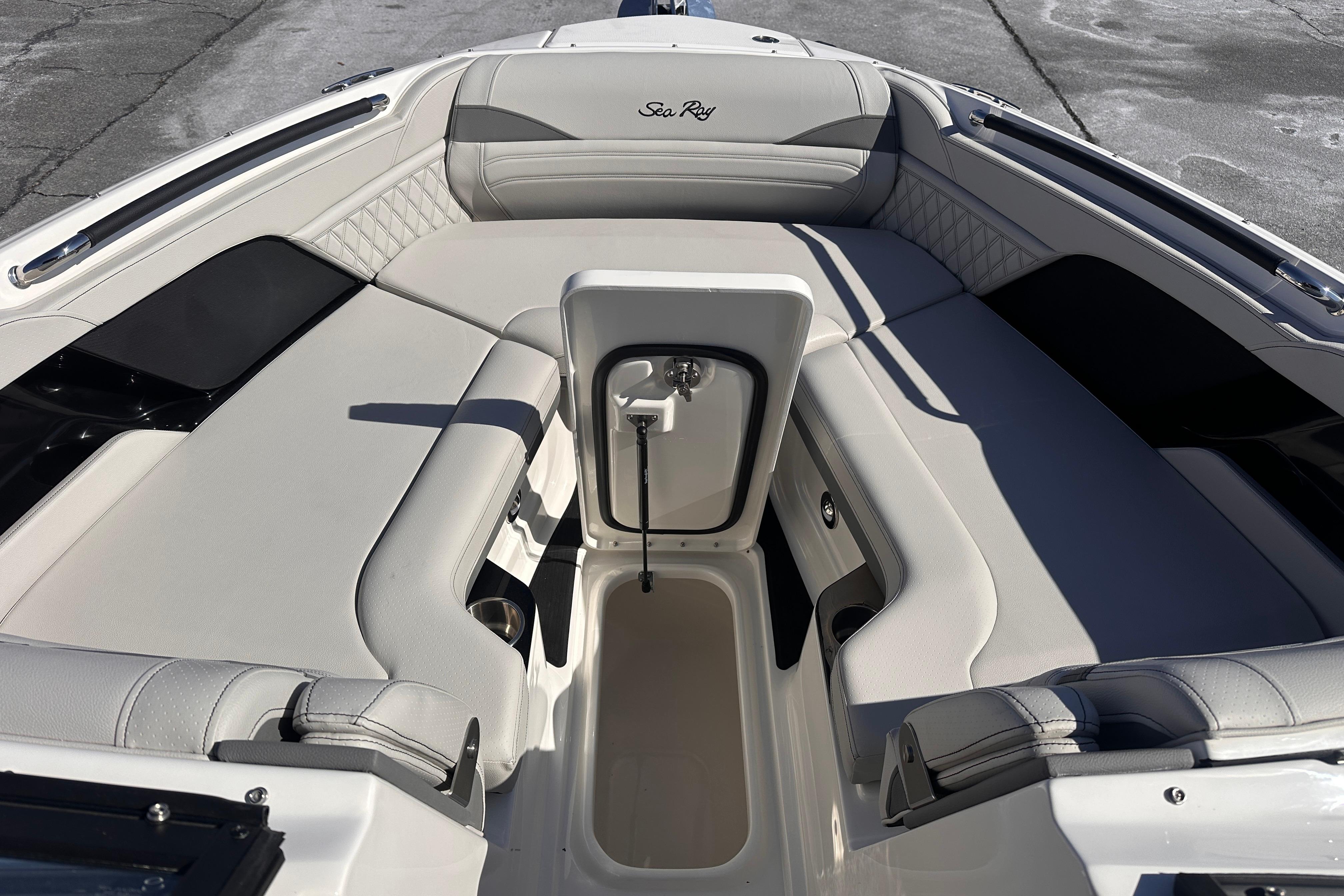 2026 Sea Ray SLX 260 Outboard boat interior with luxurious seating and storage compartment.