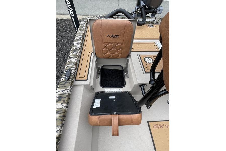 2026 Avid 21 FSX boat seat with storage compartment open, featuring brown upholstery.