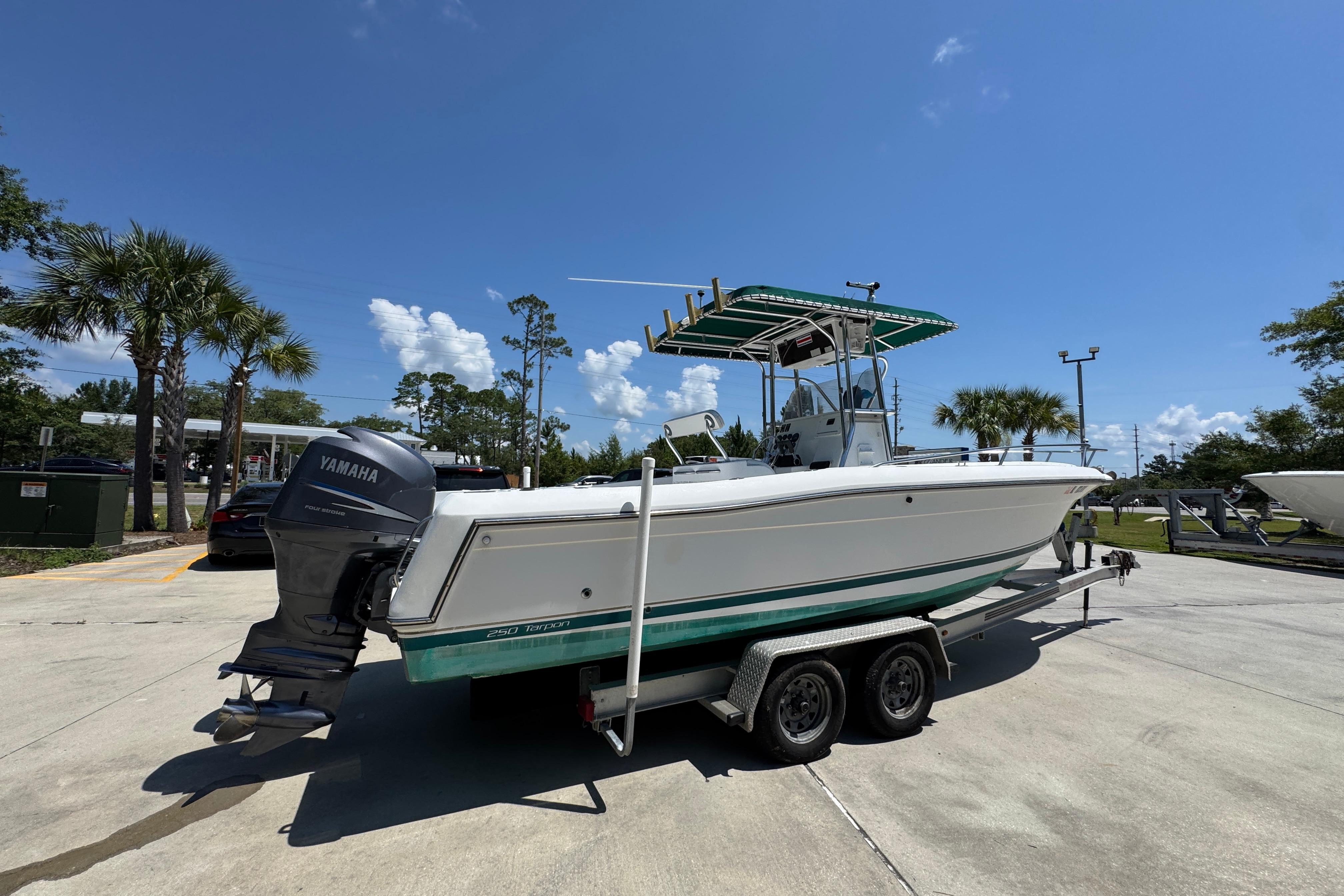 2000 Stamas 250 Tarpon boat on trailer with Yamaha outboard motor, parked outdoors.