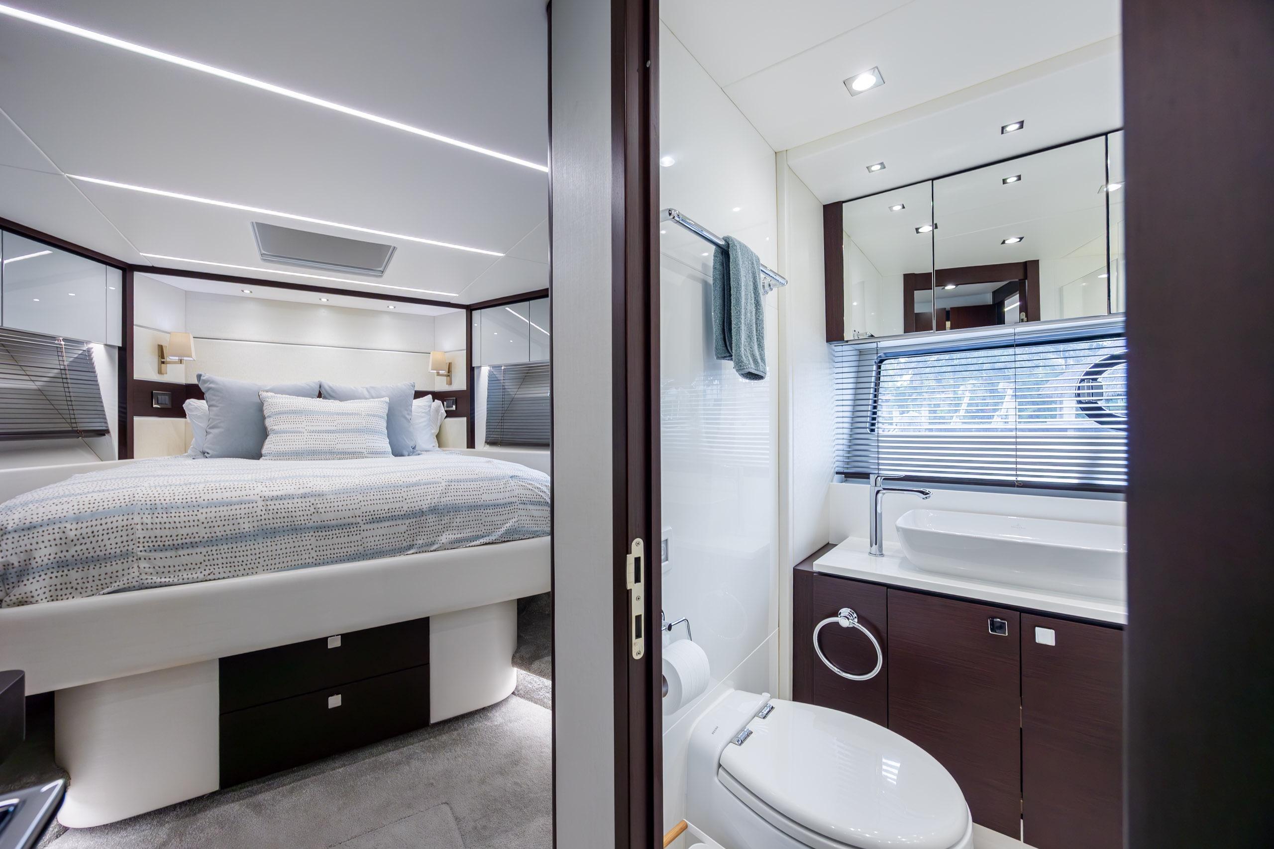 Luxurious interior of 2020 Sunseeker Predator 74 XPS yacht with bedroom and bathroom.