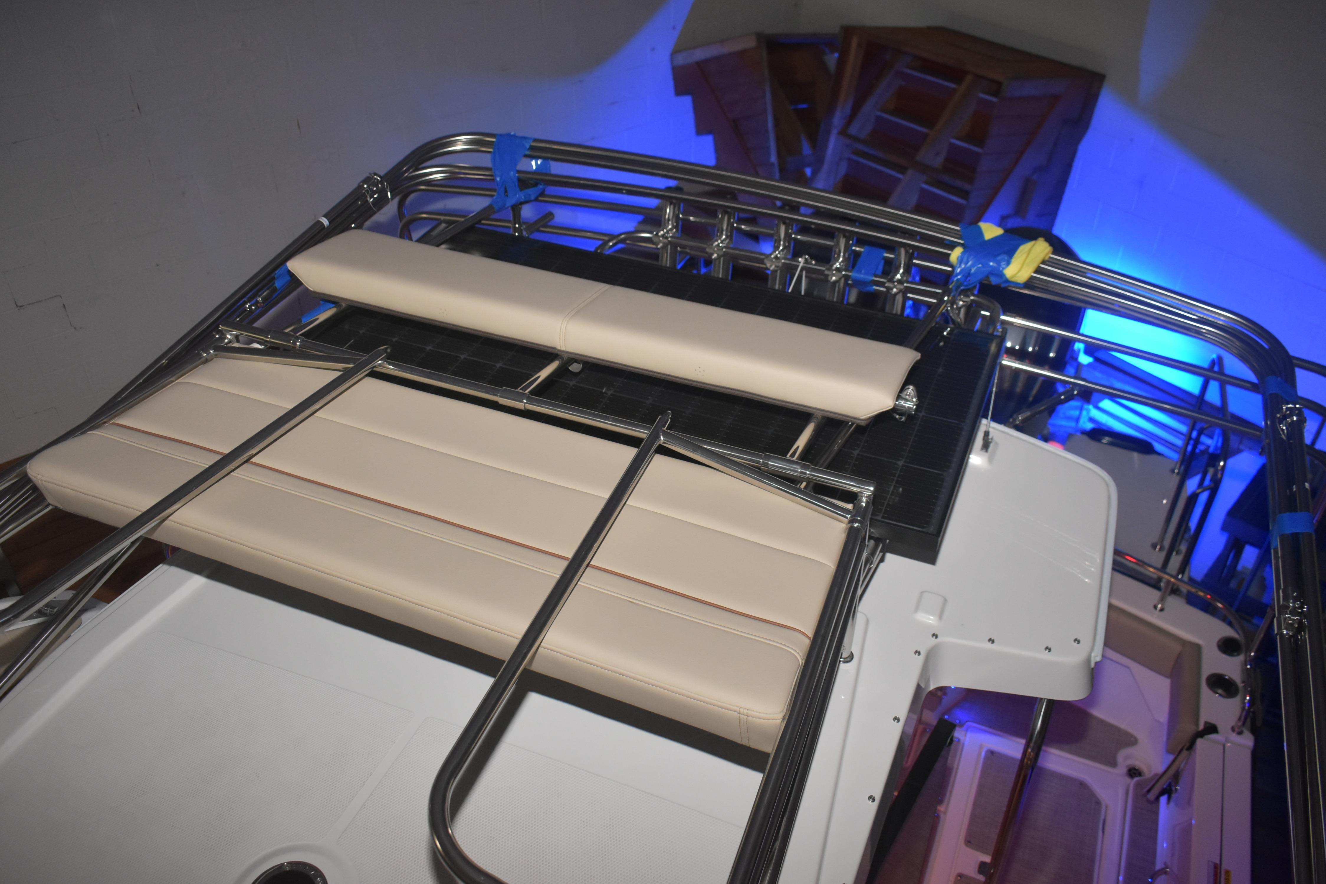2026 Cutwater C-32 CB boat interior with cushioned seating and stainless steel railings.
