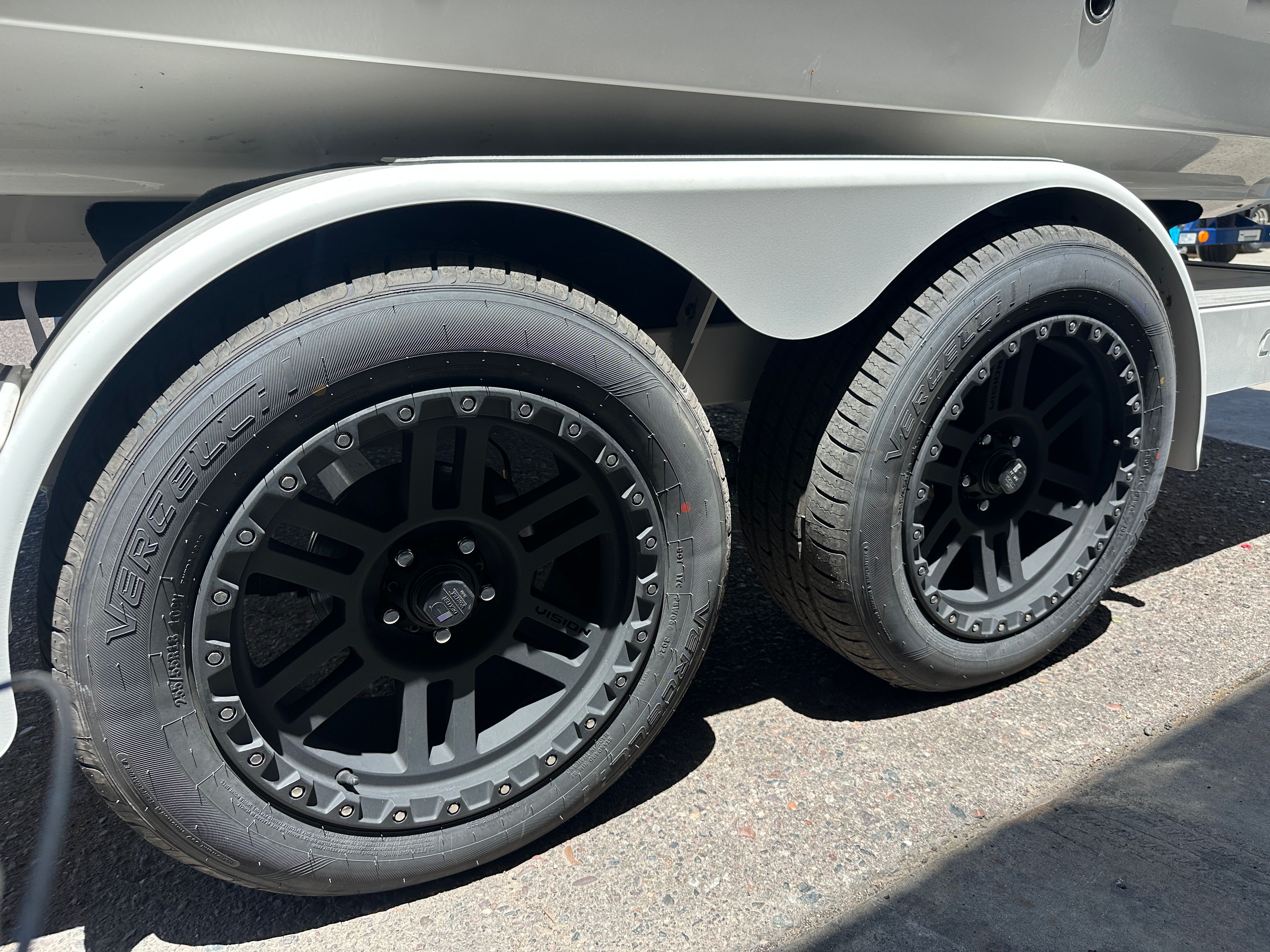 Close-up of two black tires on a boat trailer.