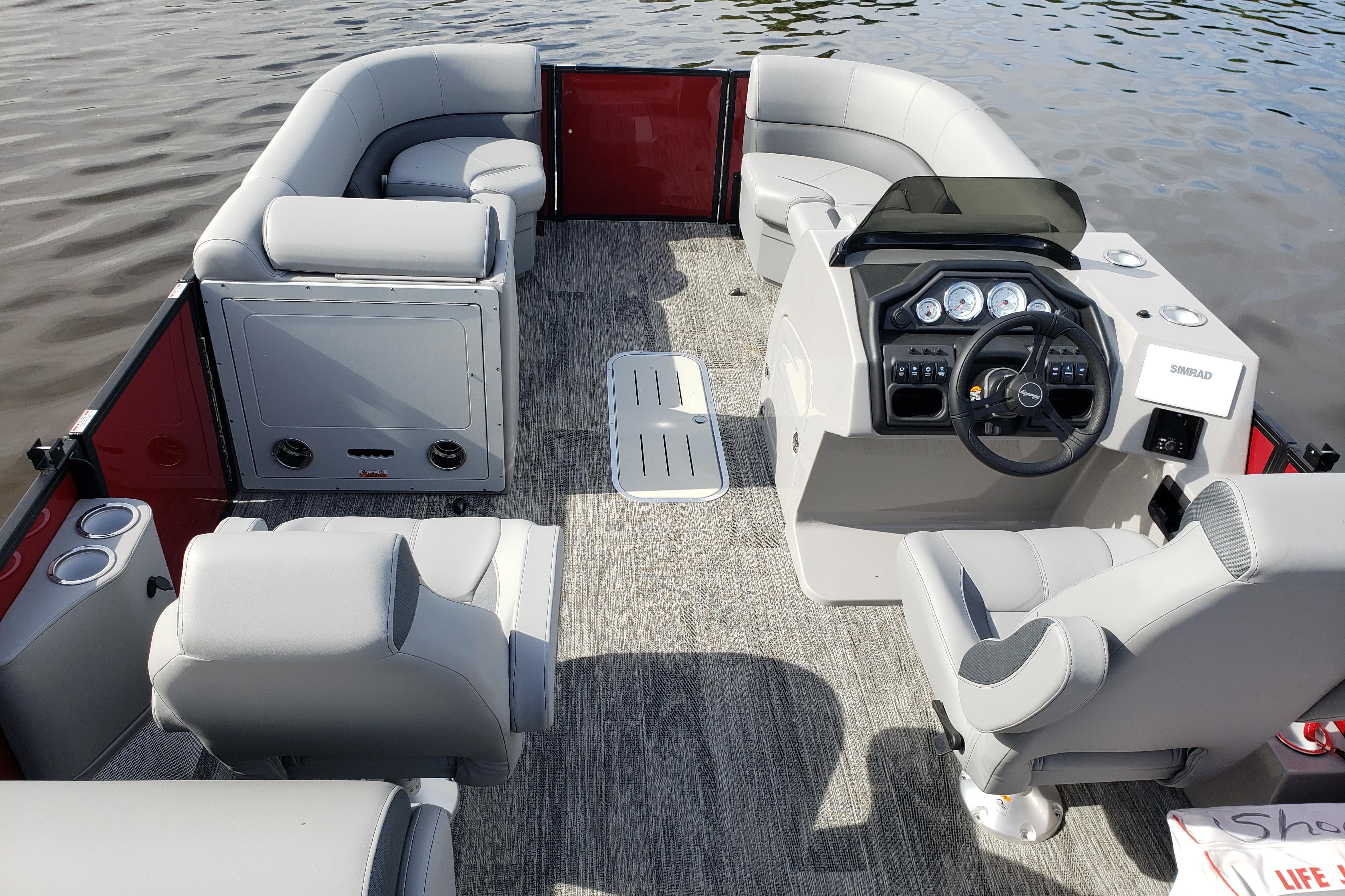 2026 Bentley Pontoons Legacy 243 Navigator Ext interior with gray seating and modern dashboard.