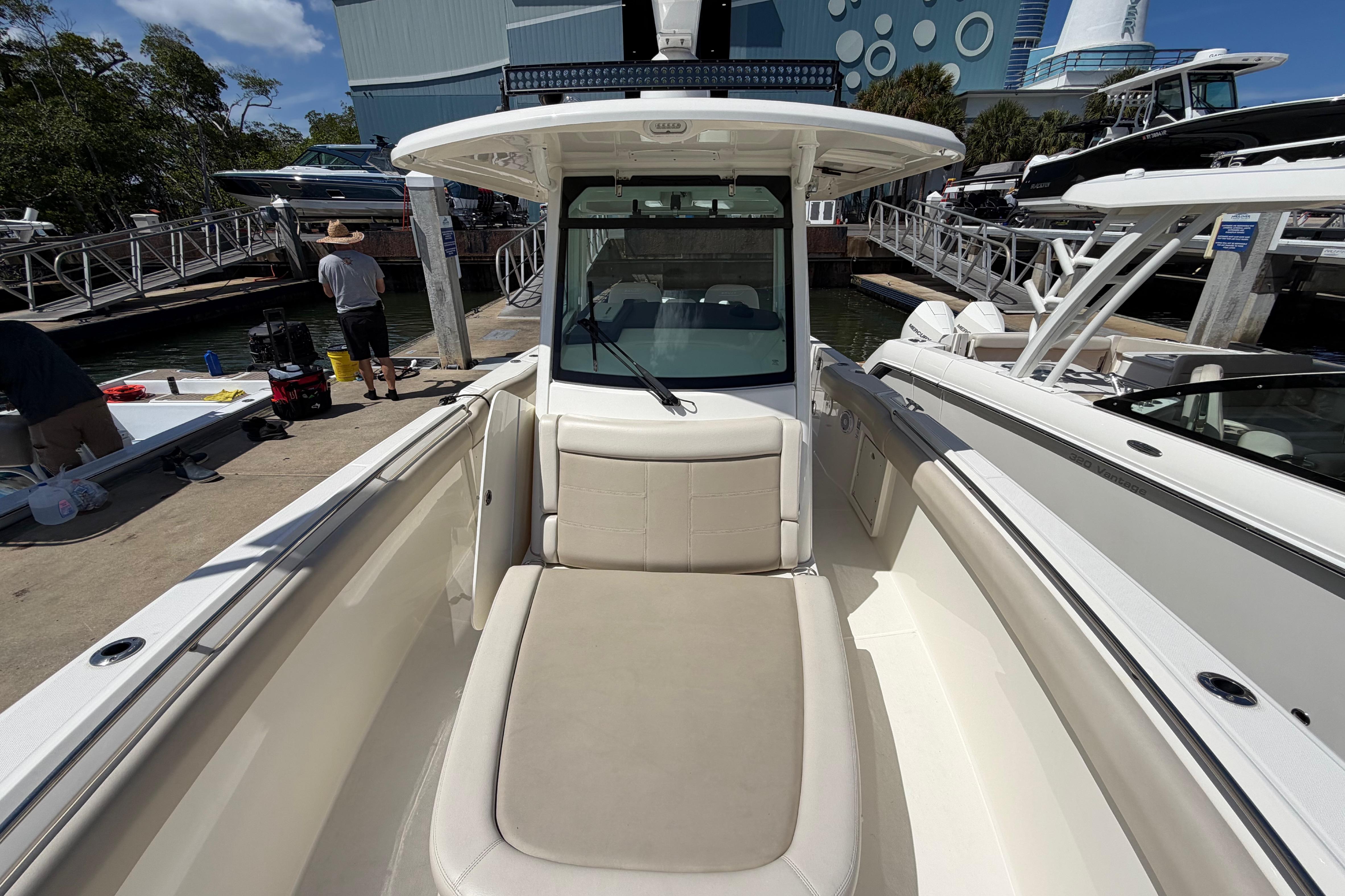 2019 Boston Whaler 330 Outrage boat docked, showcasing spacious seating and sleek design.