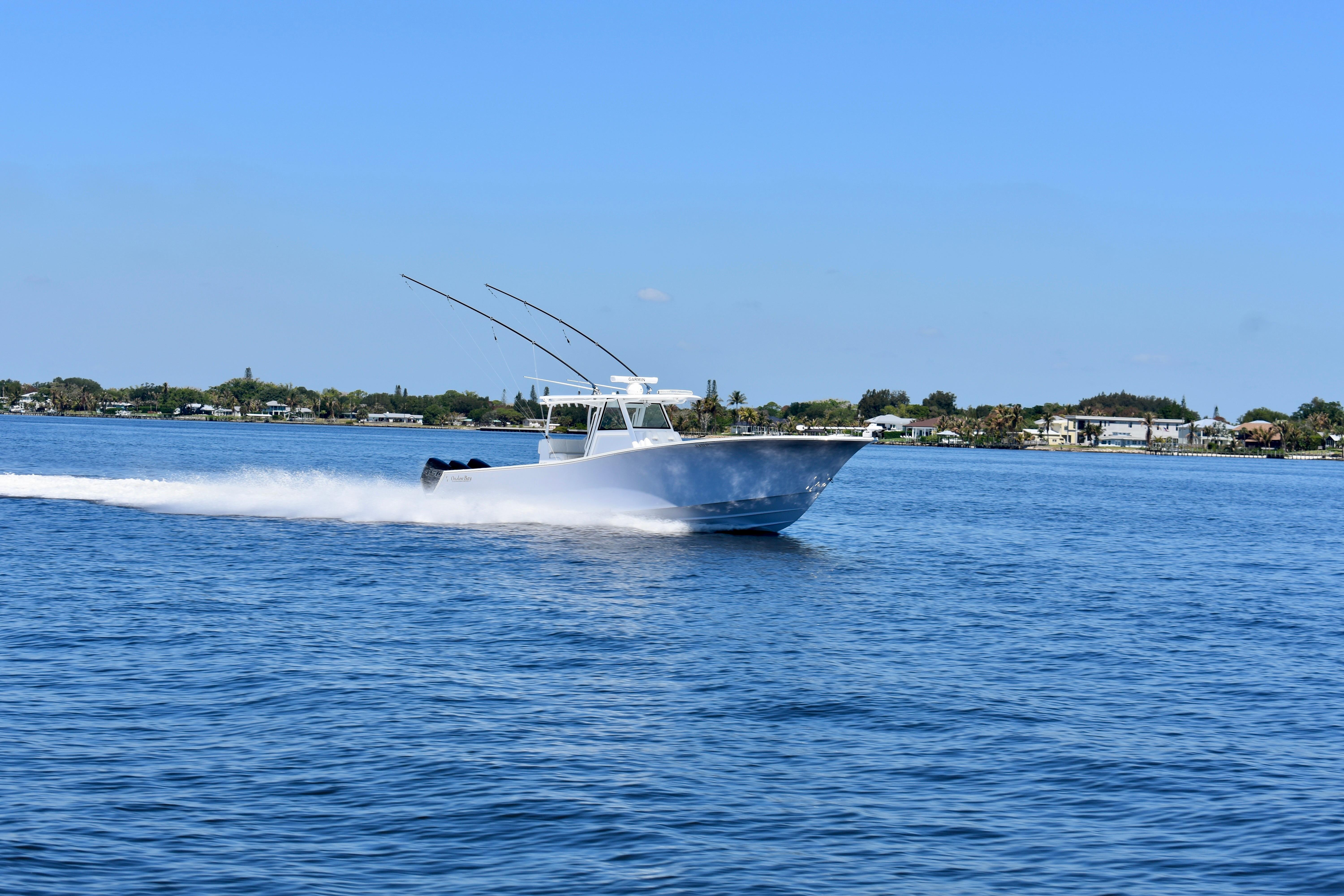 2022 Onslow Bay 41 Tournament boat speeding on open water under clear blue sky.