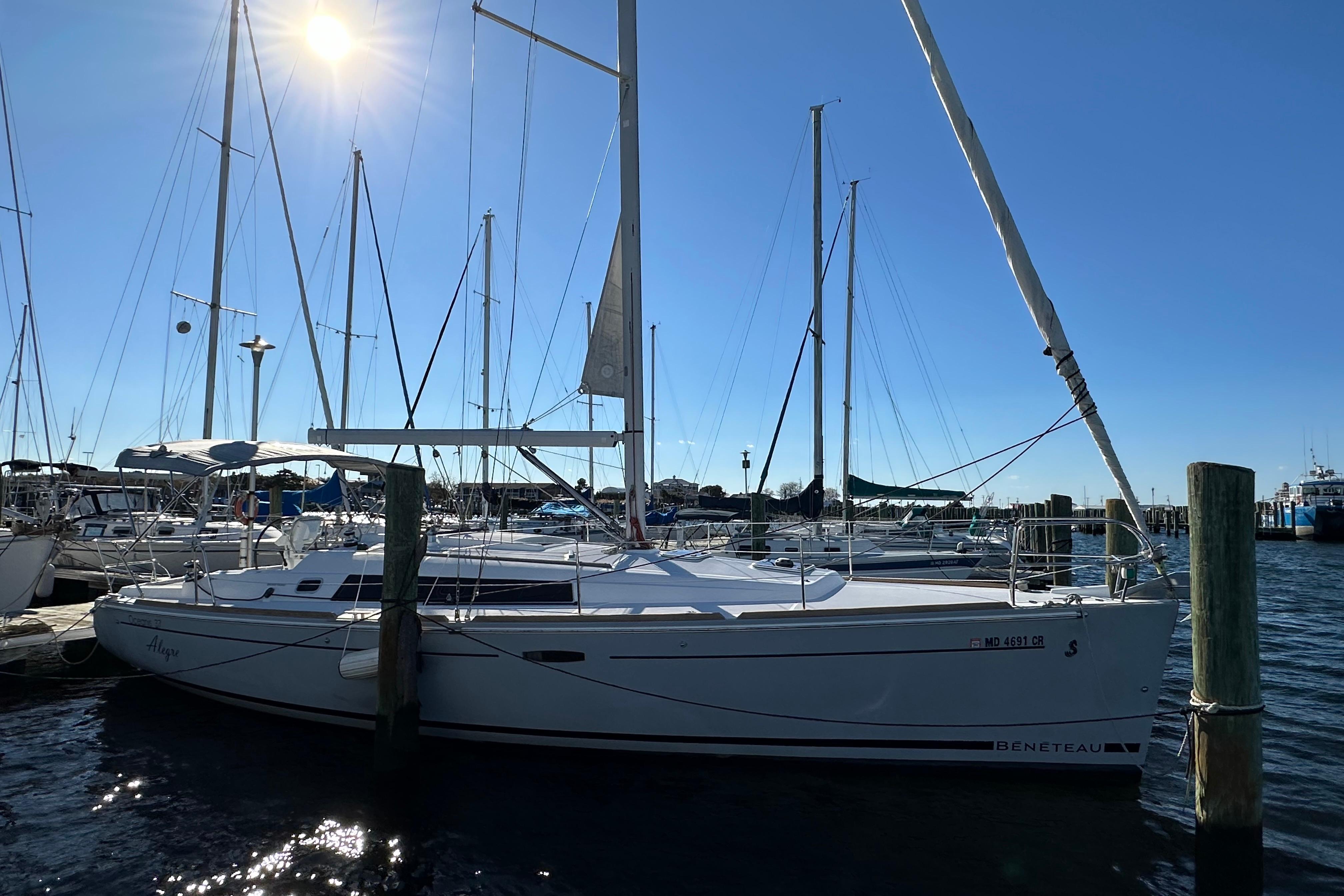 2015 Beneteau Oceanis 37 sailboat docked under clear blue sky.