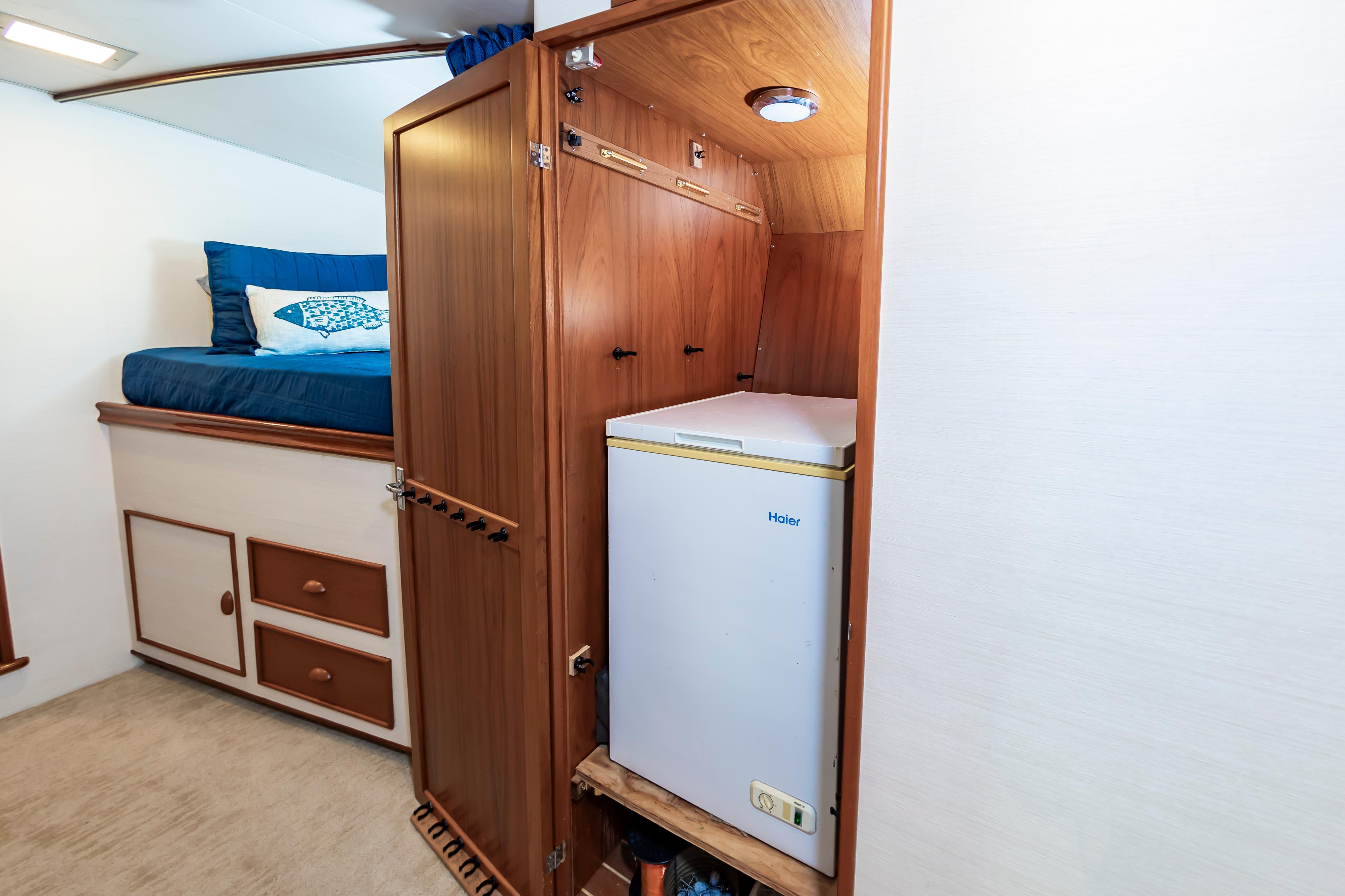 Interior of 1993 Custom Carolina Scarborough 56 Convertible with bed, storage, and Haier fridge.