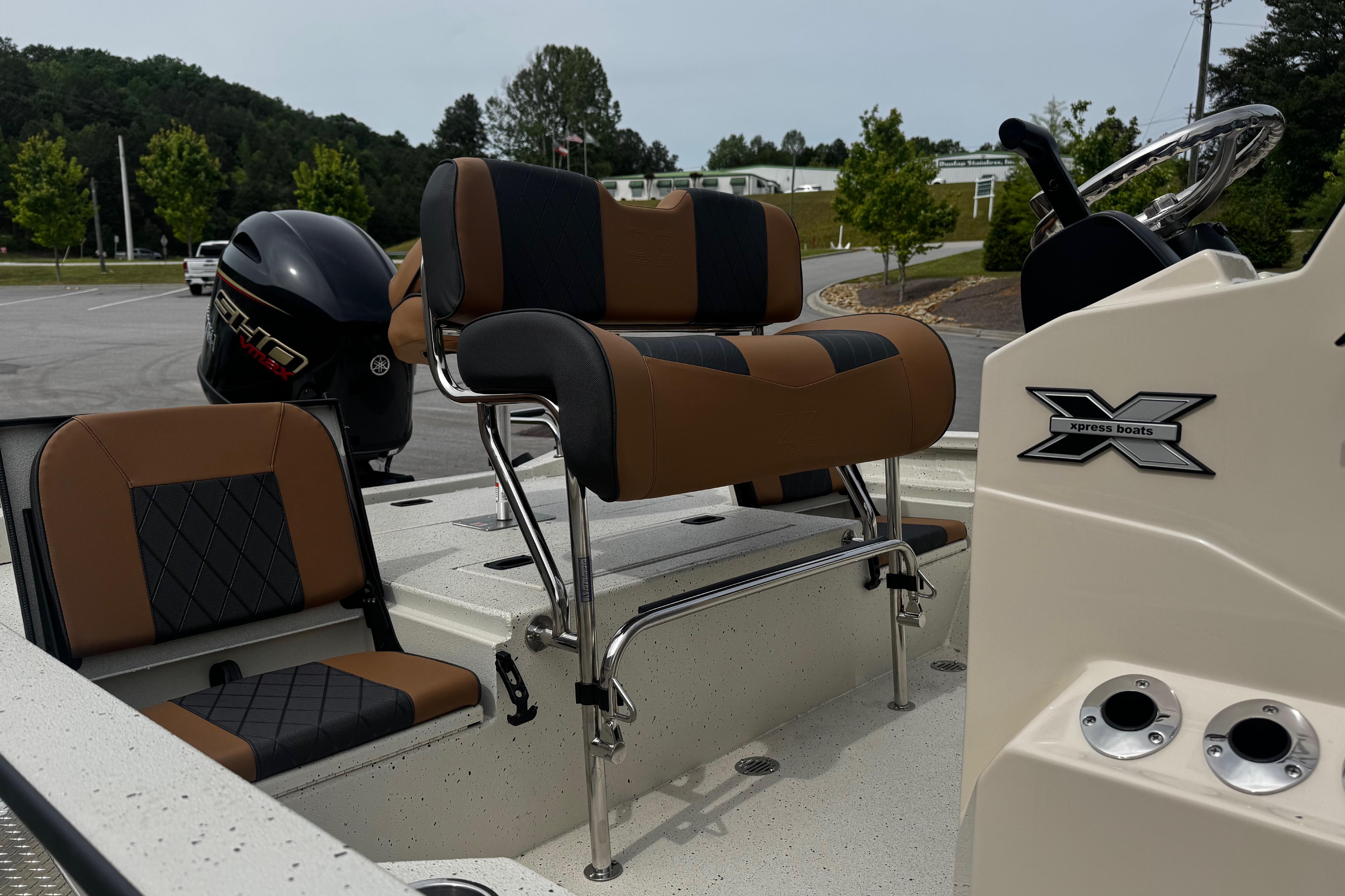 2026 Xpress H20B Bay boat interior with seating and steering console.