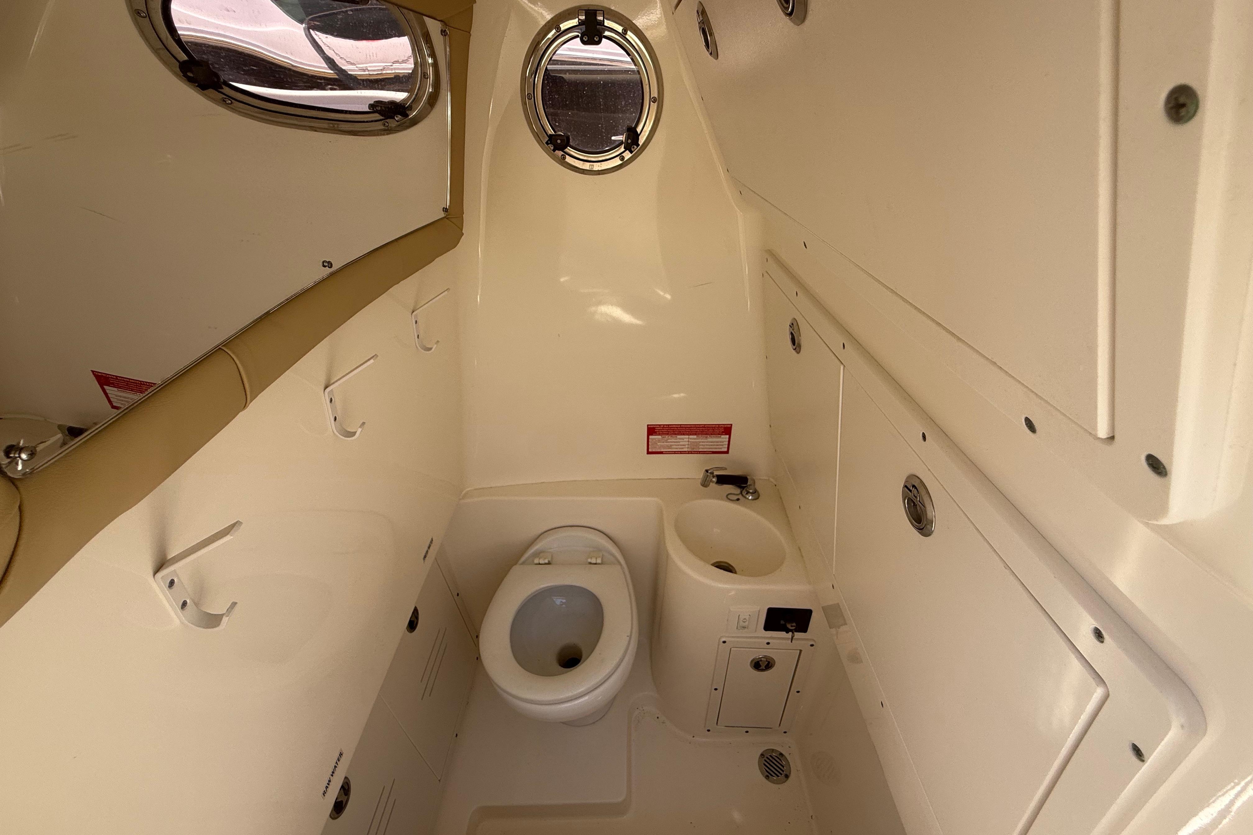 2019 Key West Billistic 281 Center Console boat interior with toilet and sink.
