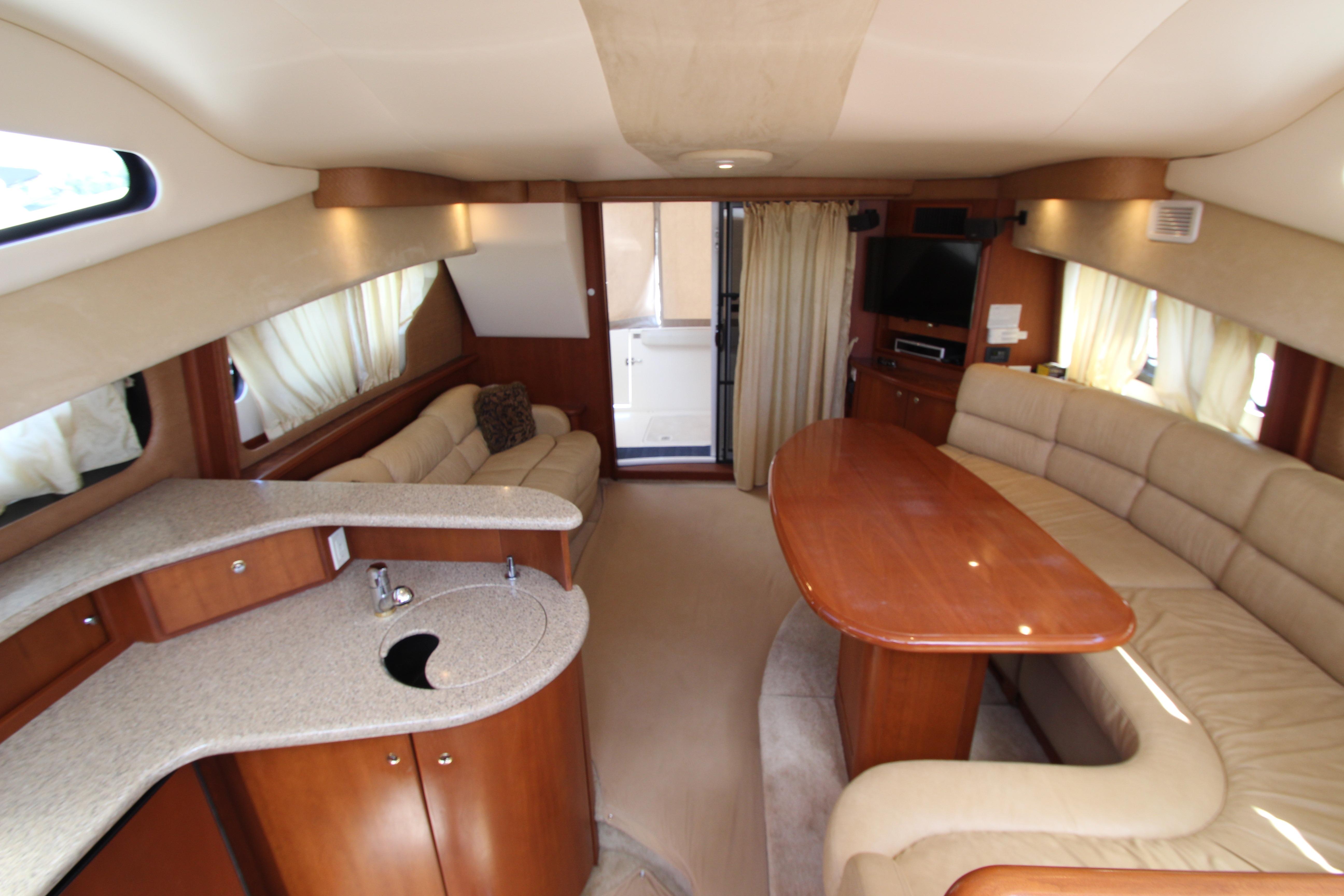 Luxurious interior of 2006 Silverton 38 Sport Bridge yacht with elegant seating and kitchenette.