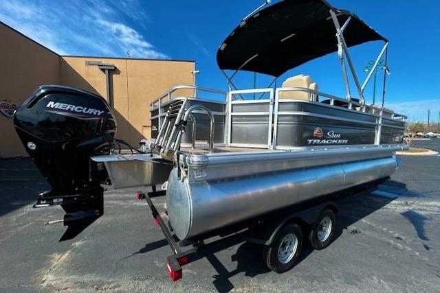2025 Sun Tracker Fishin' Barge 20 DLX pontoon boat with Mercury engine on trailer.