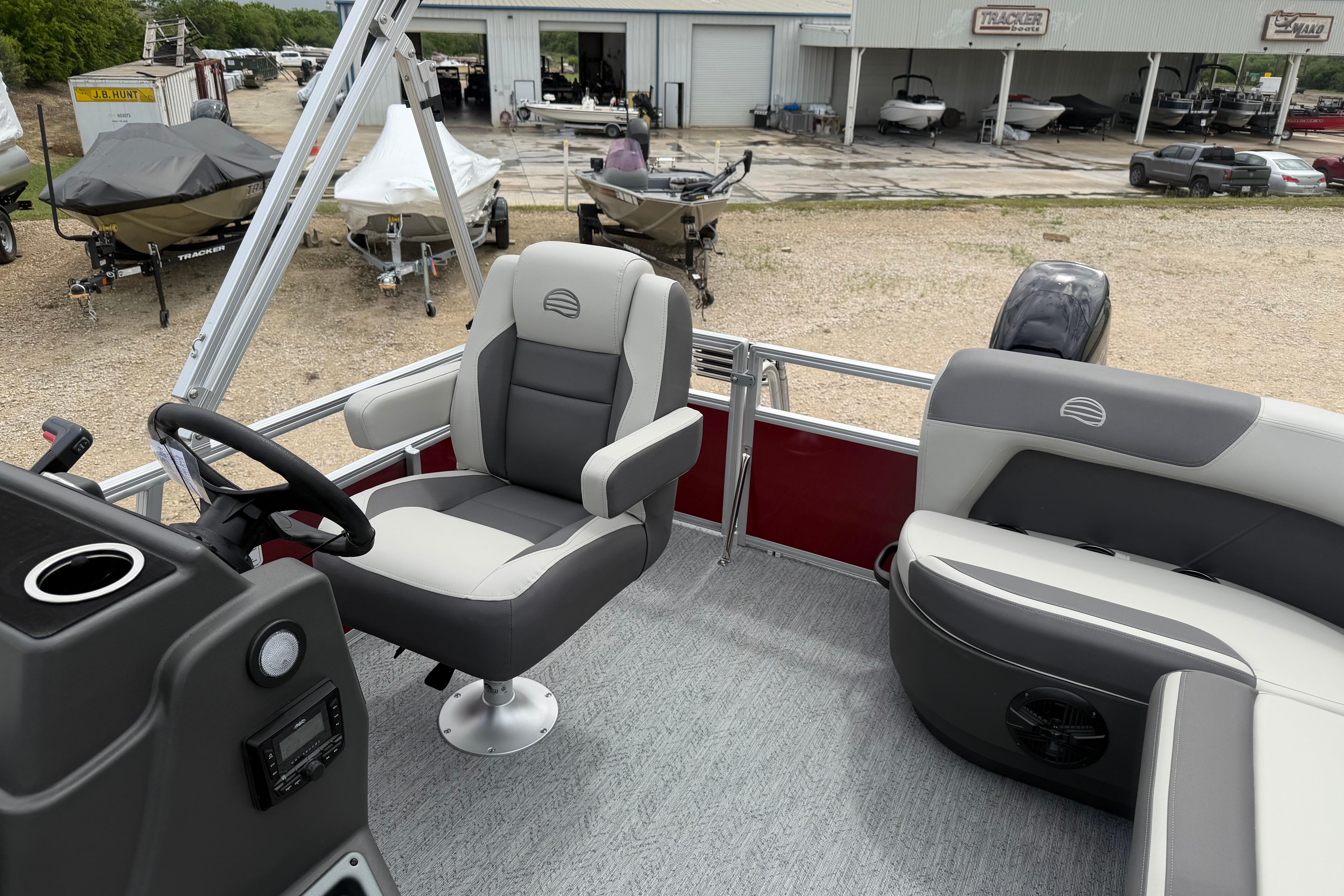 2026 Sun Tracker Bass Buggy 16 XL Select pontoon boat interior with seating and steering console.