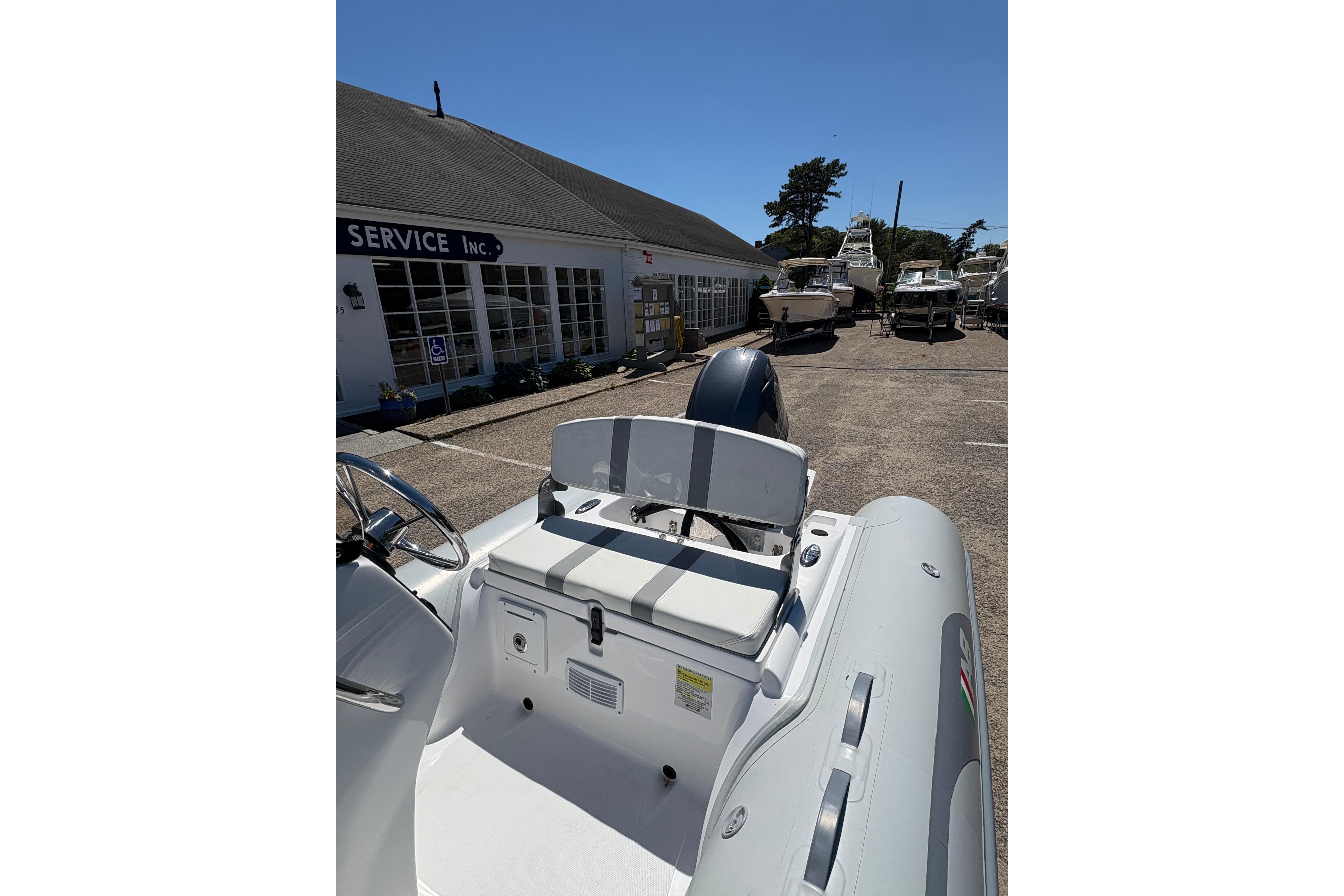 2022 AB Inflatables Oceanus 14 VST boat at a service center, showcasing seating and controls.