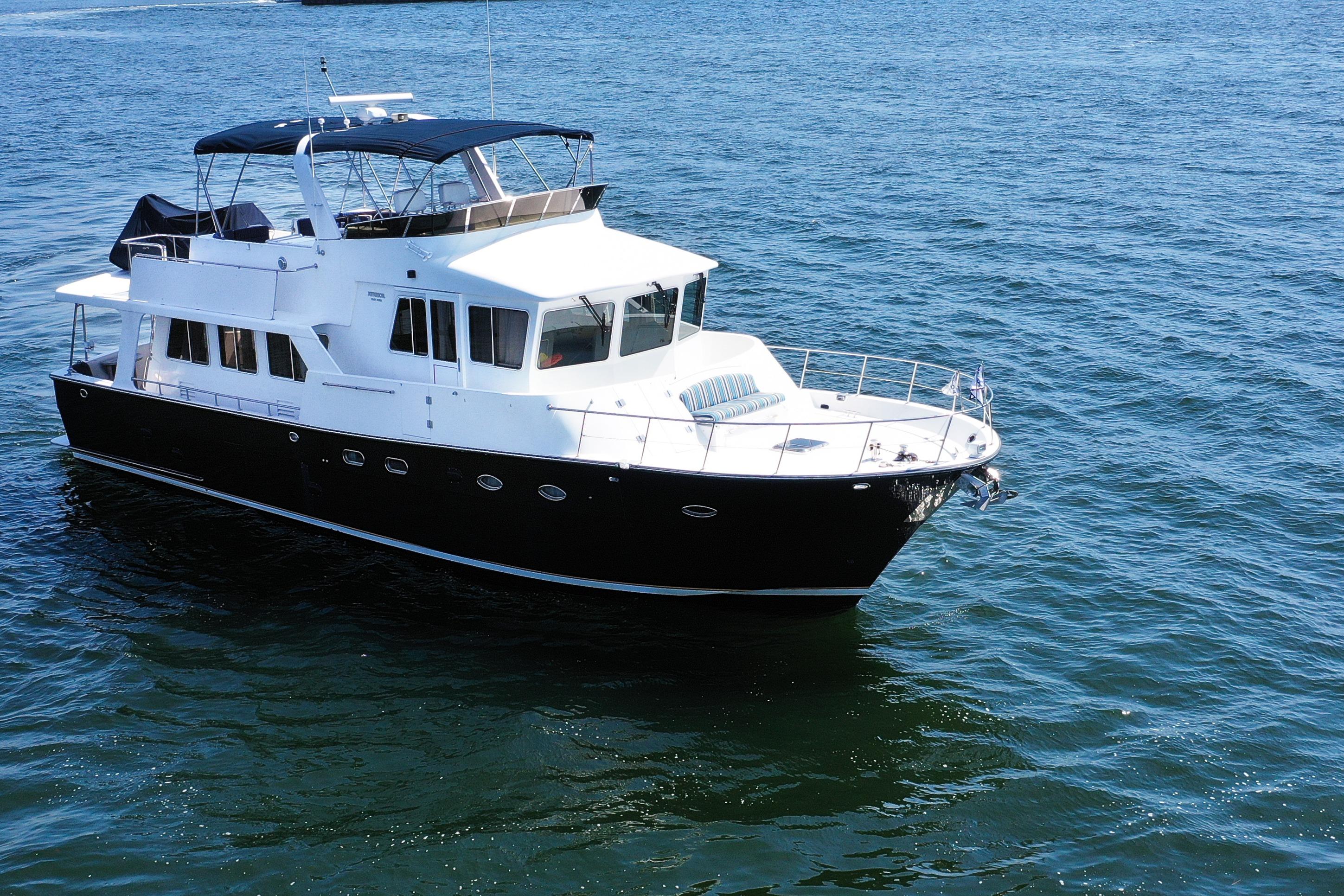 2003 Jefferson Pilothouse 57 yacht cruising on open water.