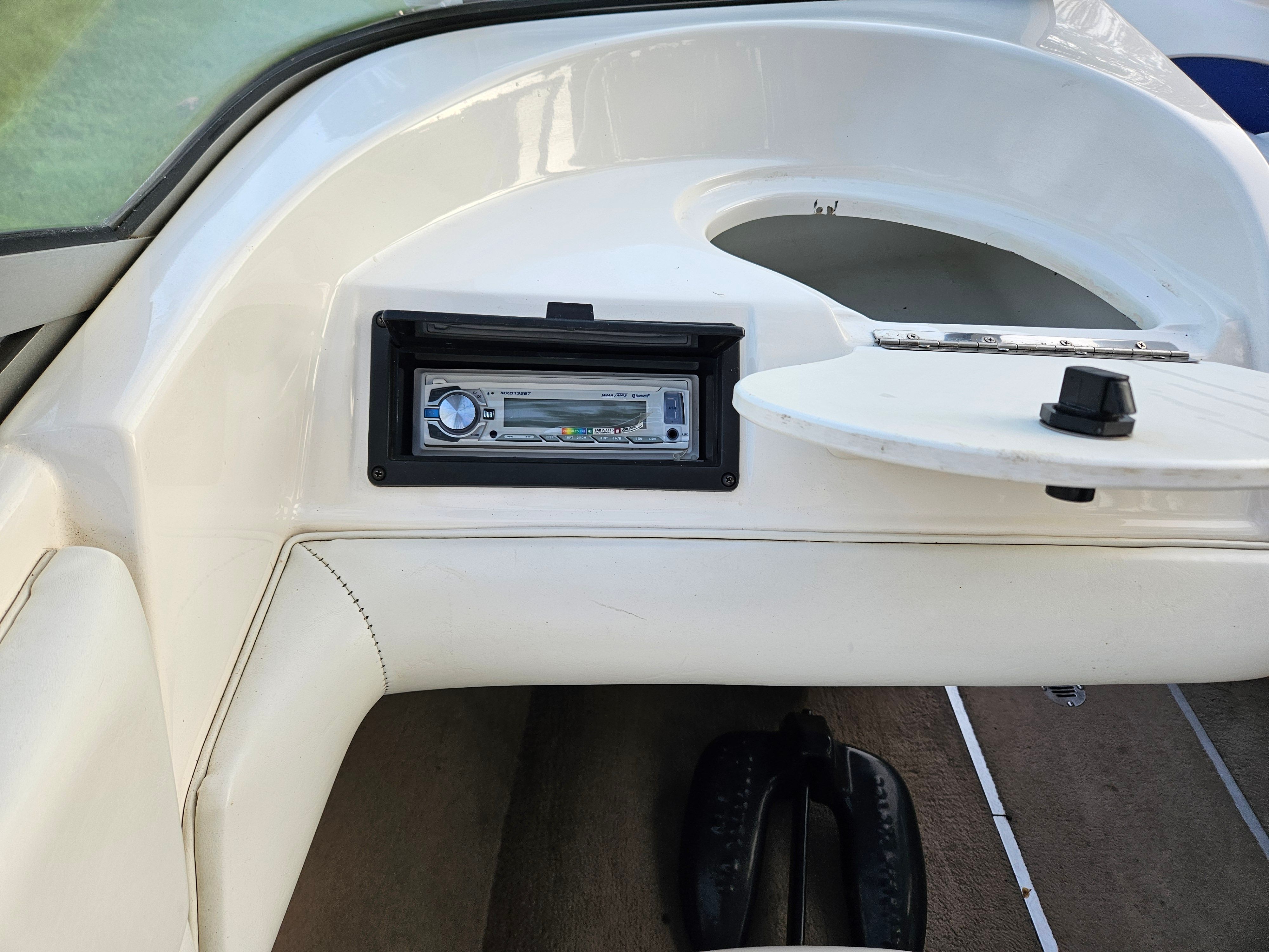 The image shows the dashboard of a 1996 Wellcraft Excel boat with a radio.