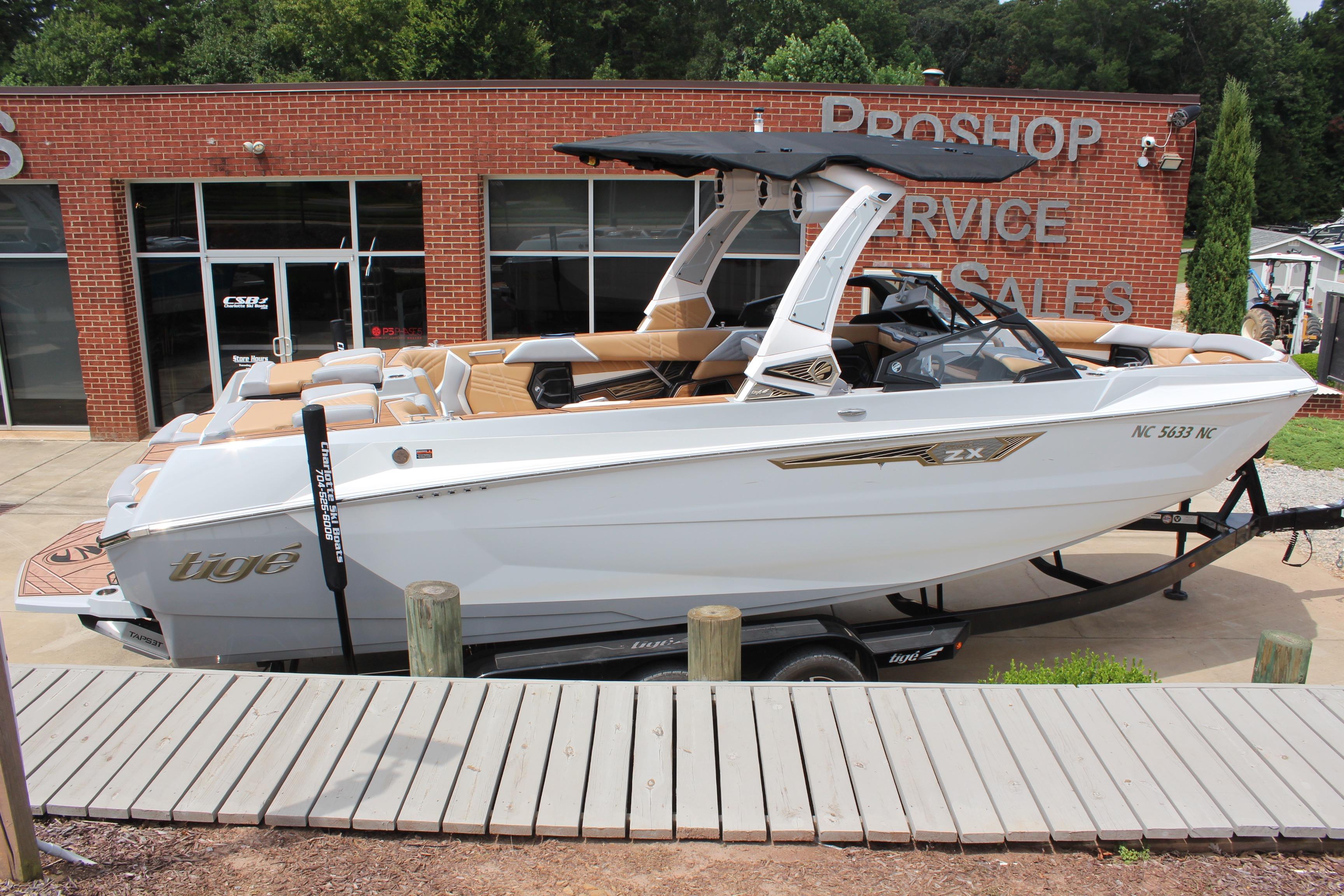 2024 Tigé Ultré 25ZX boat on trailer outside service shop.