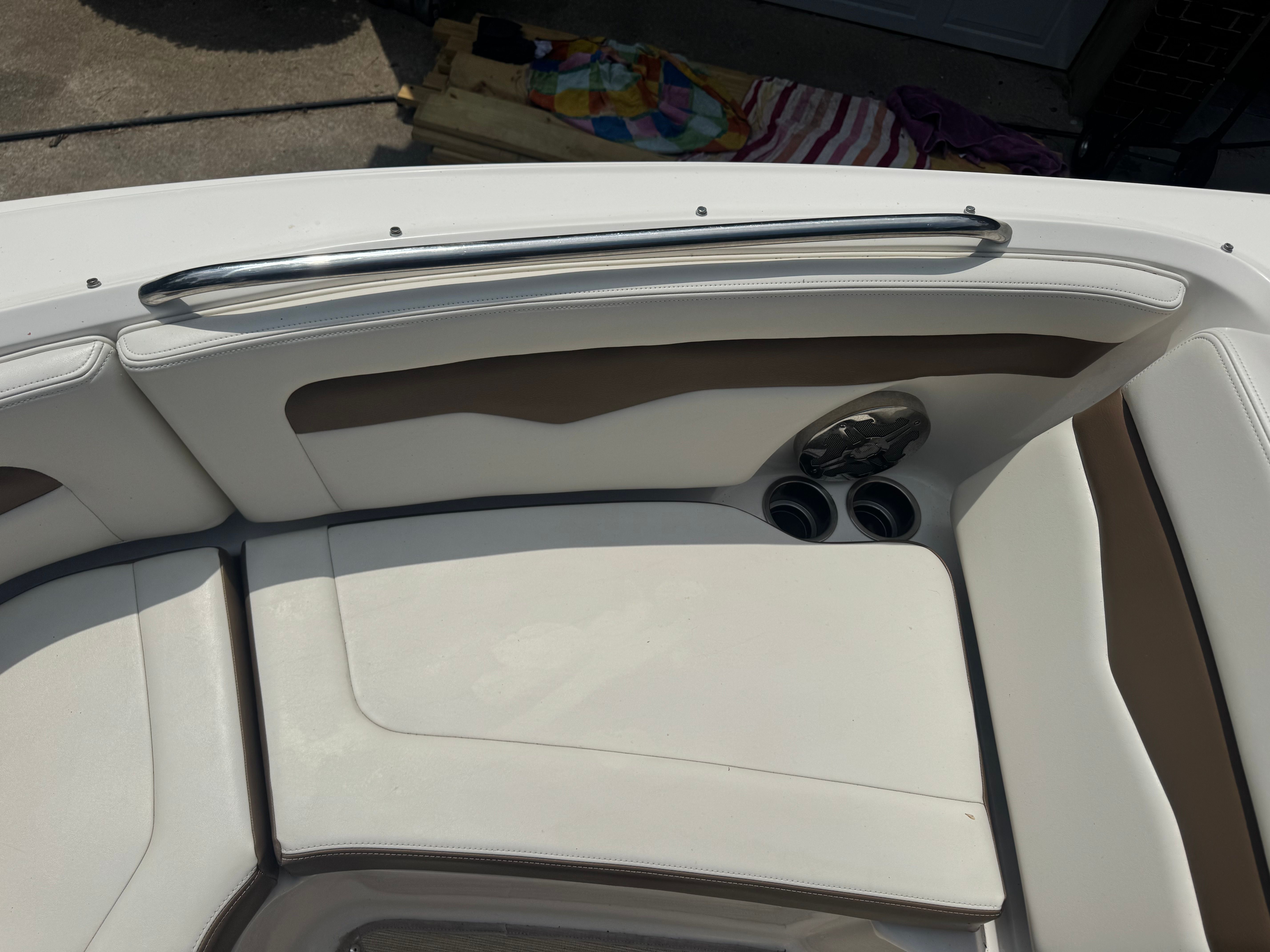 Interior of a 2016 Chaparral 246 SSi boat with beige upholstery.