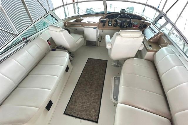 2004 Carver 360 Mariner cockpit with white seating and helm controls.