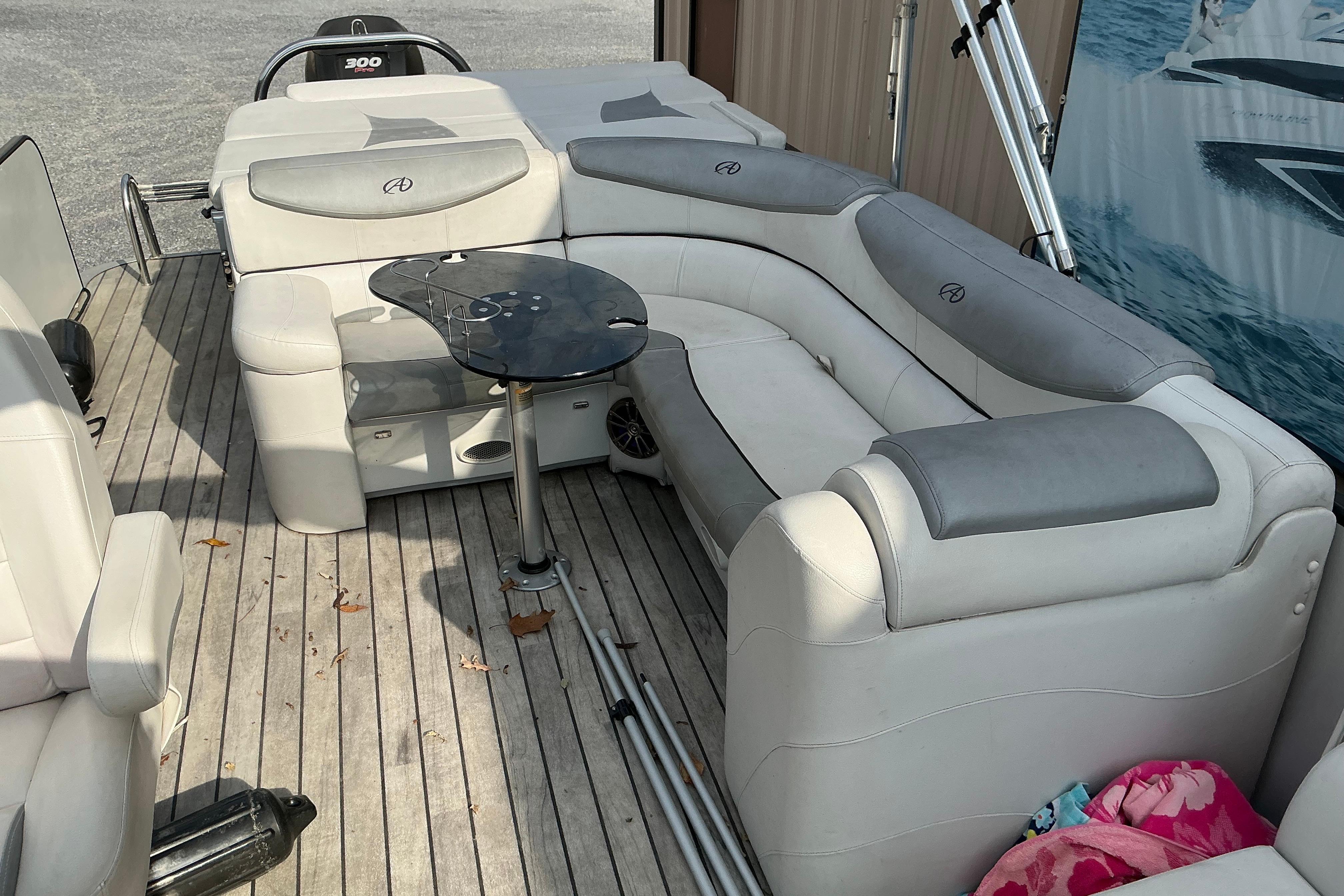 Luxurious seating on a 2014 Avalon 25 ft. Paradise Elite pontoon boat with a sleek table.