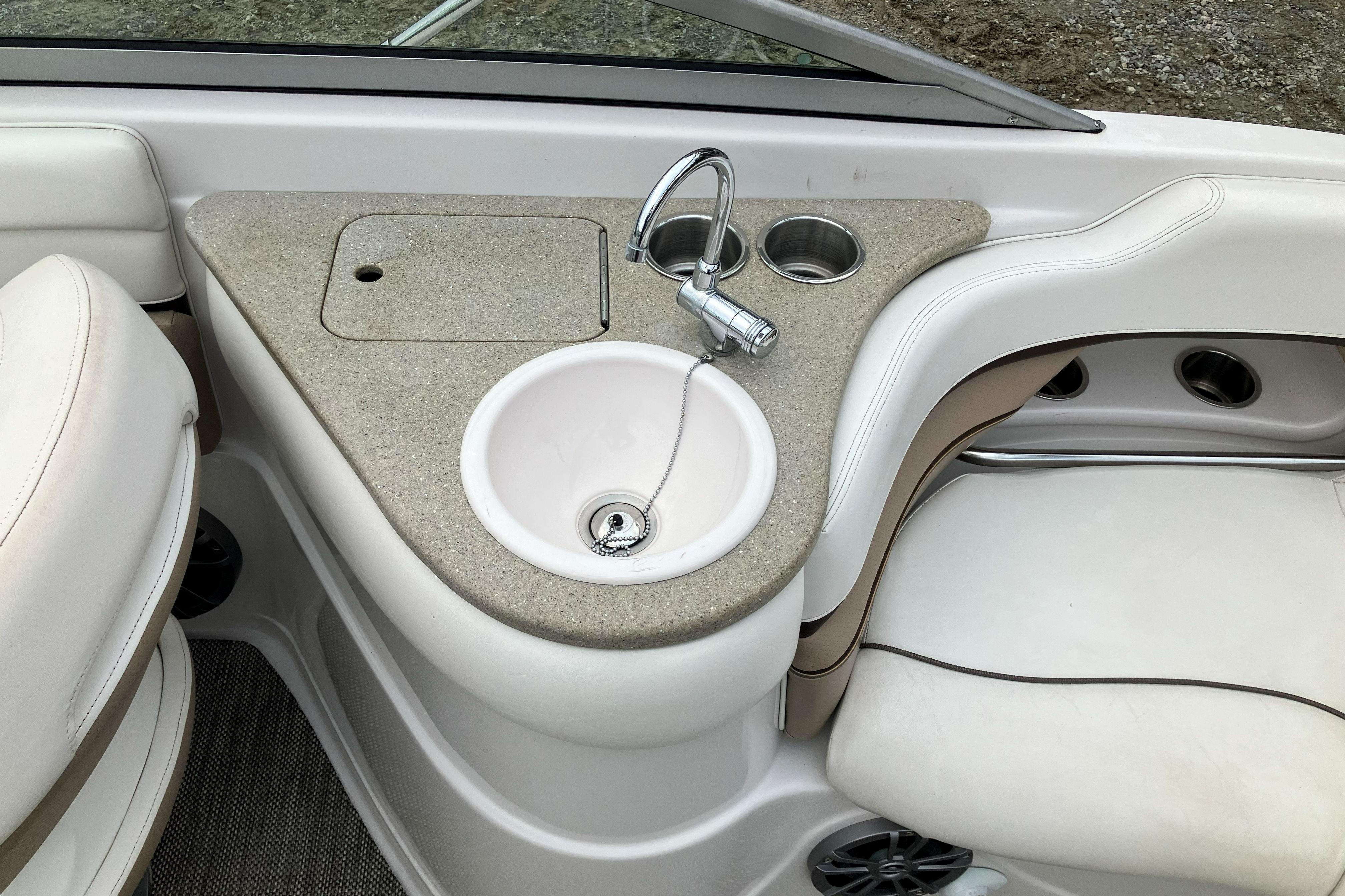 2006 Four Winns 240 Horizon boat interior with sink and seating area.