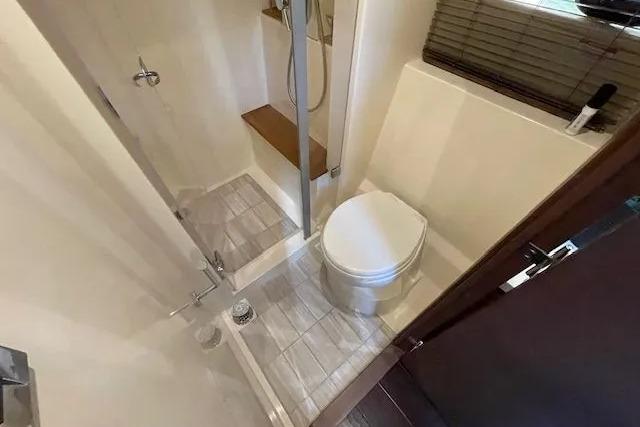 2016 Sea Ray Sundancer 510 bathroom with shower and toilet, featuring modern design and compact layout.