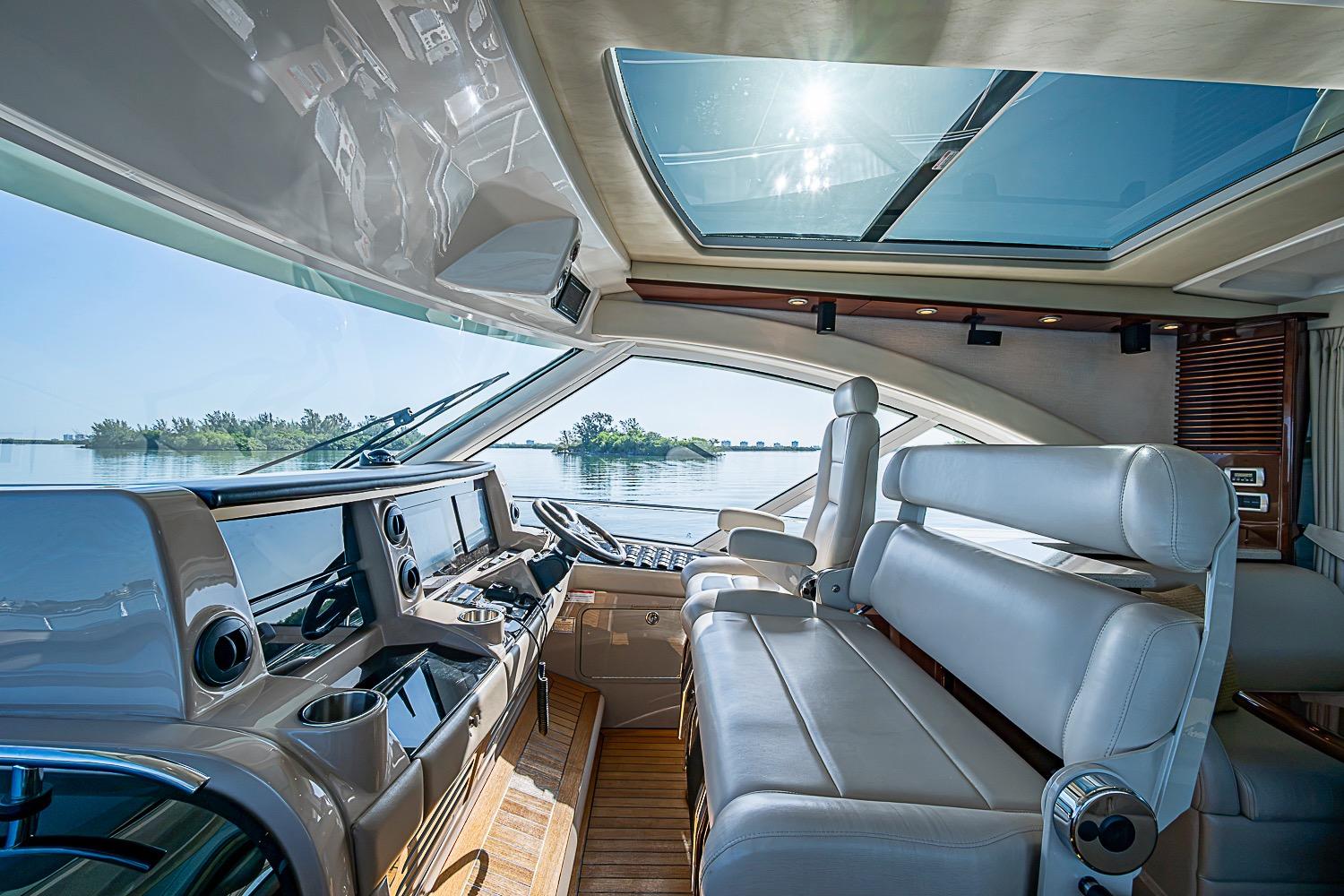 Luxurious interior of 2008 Sea Ray 60 Sundancer yacht with panoramic windows and plush seating.