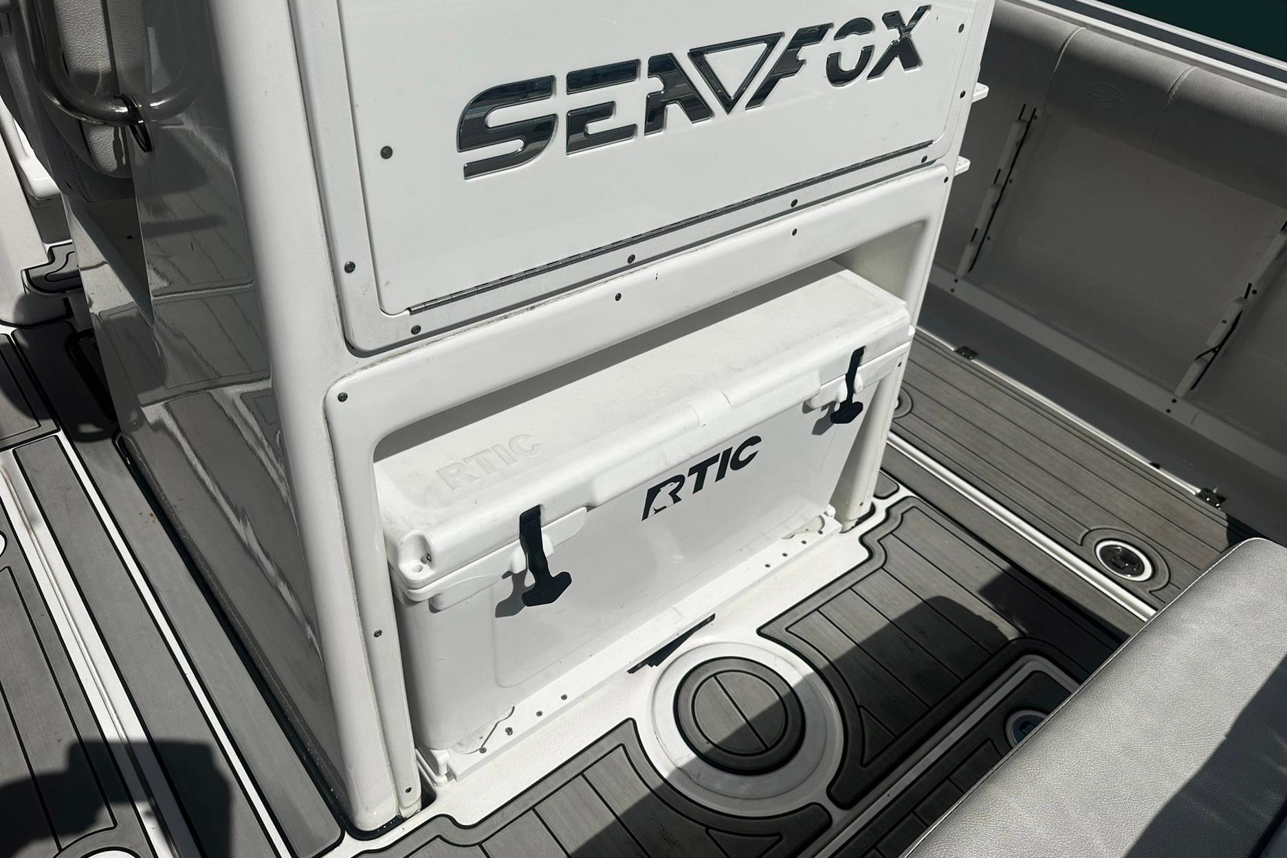 Sea Fox 228 Commander 2002 boat interior with RTIC cooler on deck.