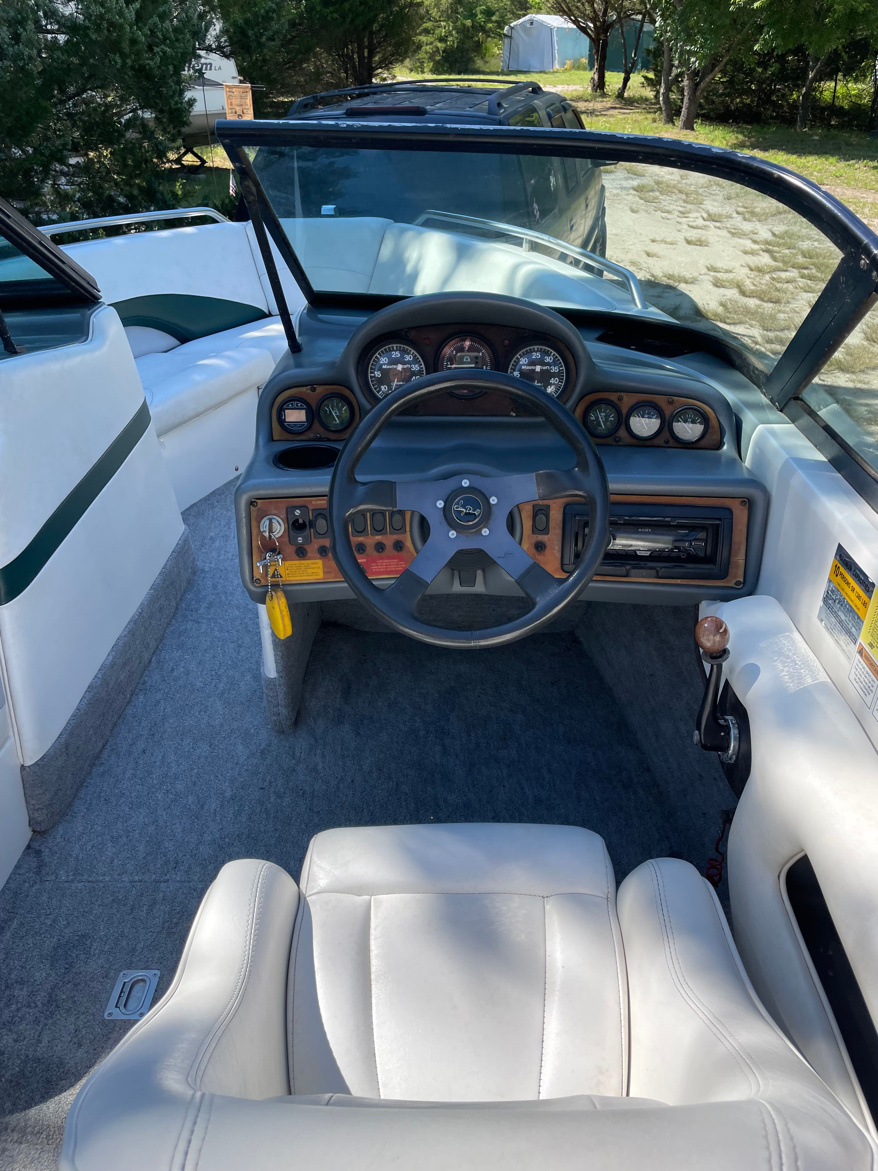 Interior of a 1997 MasterCraft Prostar 205 boat with steering console.