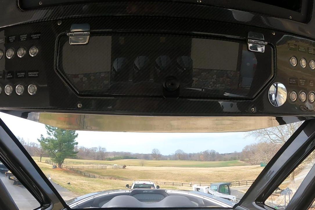 Control panel of 2018 MTI V42 boat with scenic countryside view.