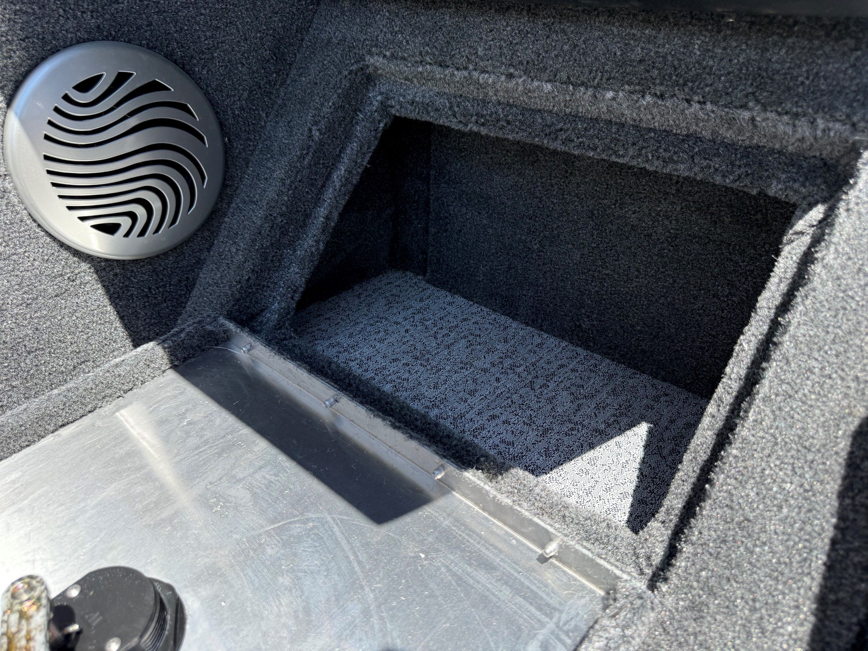 Interior of Tracker Pro Guide V175 boat, speaker and storage compartment.