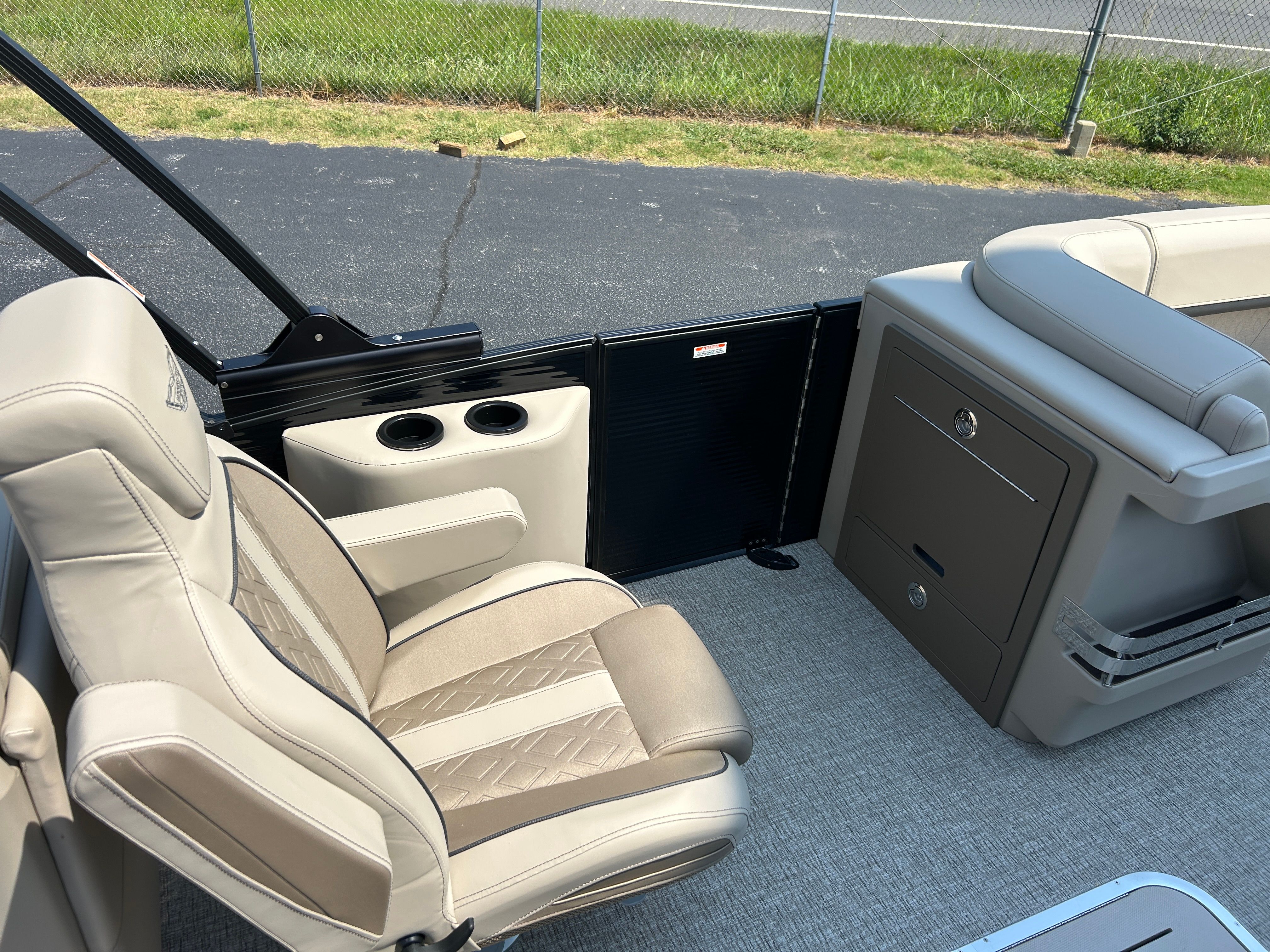 Interior of a Bennington 22 MFB with beige seating and storage.