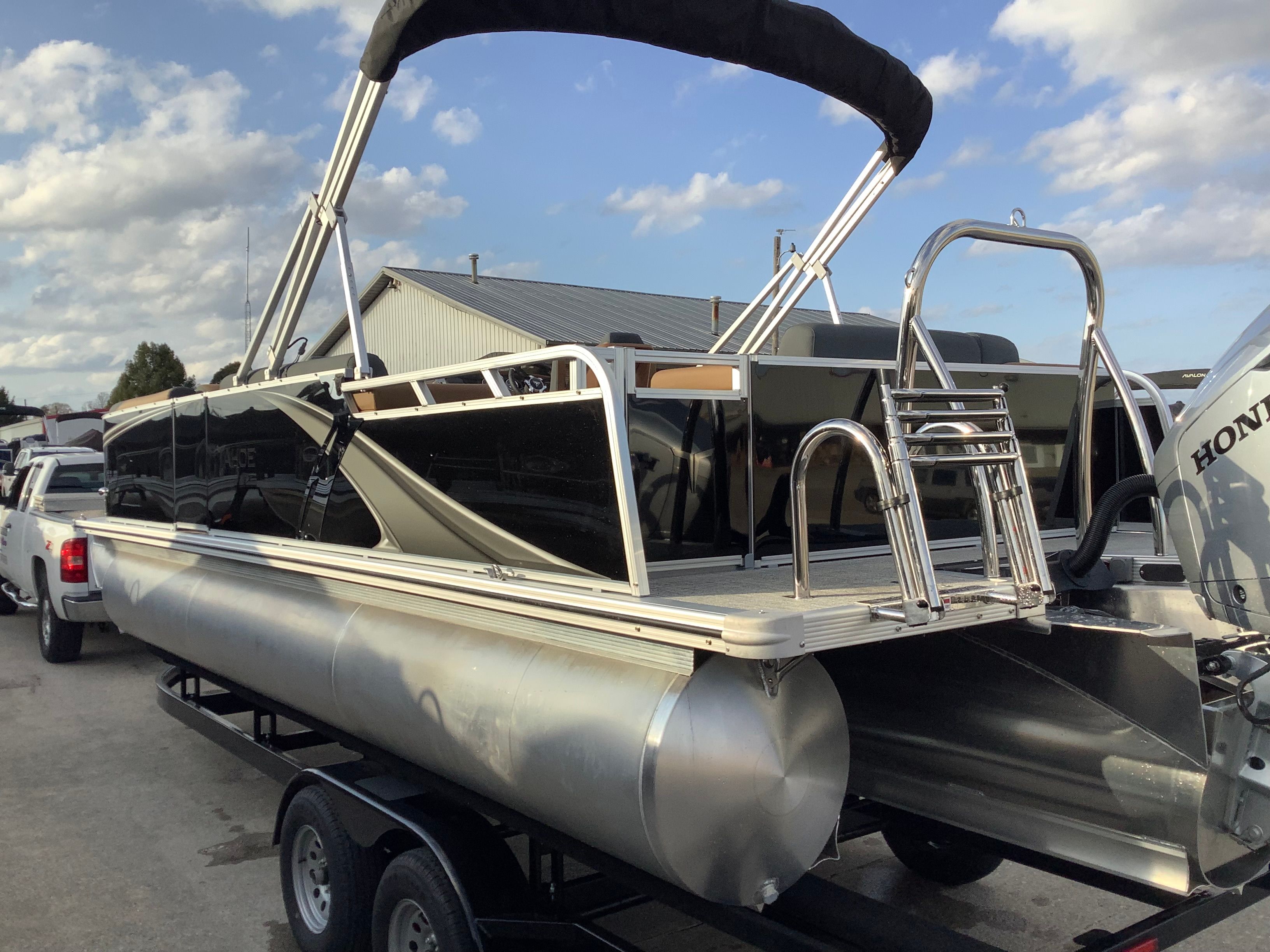 2026 Tahoe 2385 LTZ pontoon boat on trailer, glossy black finish.