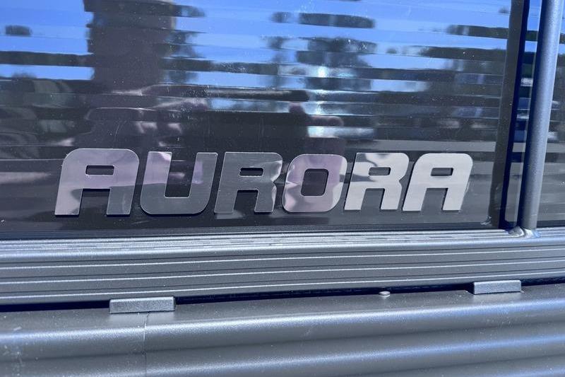Manitou Aurora 23 RF SHP 2027 model nameplate on sleek black surface.