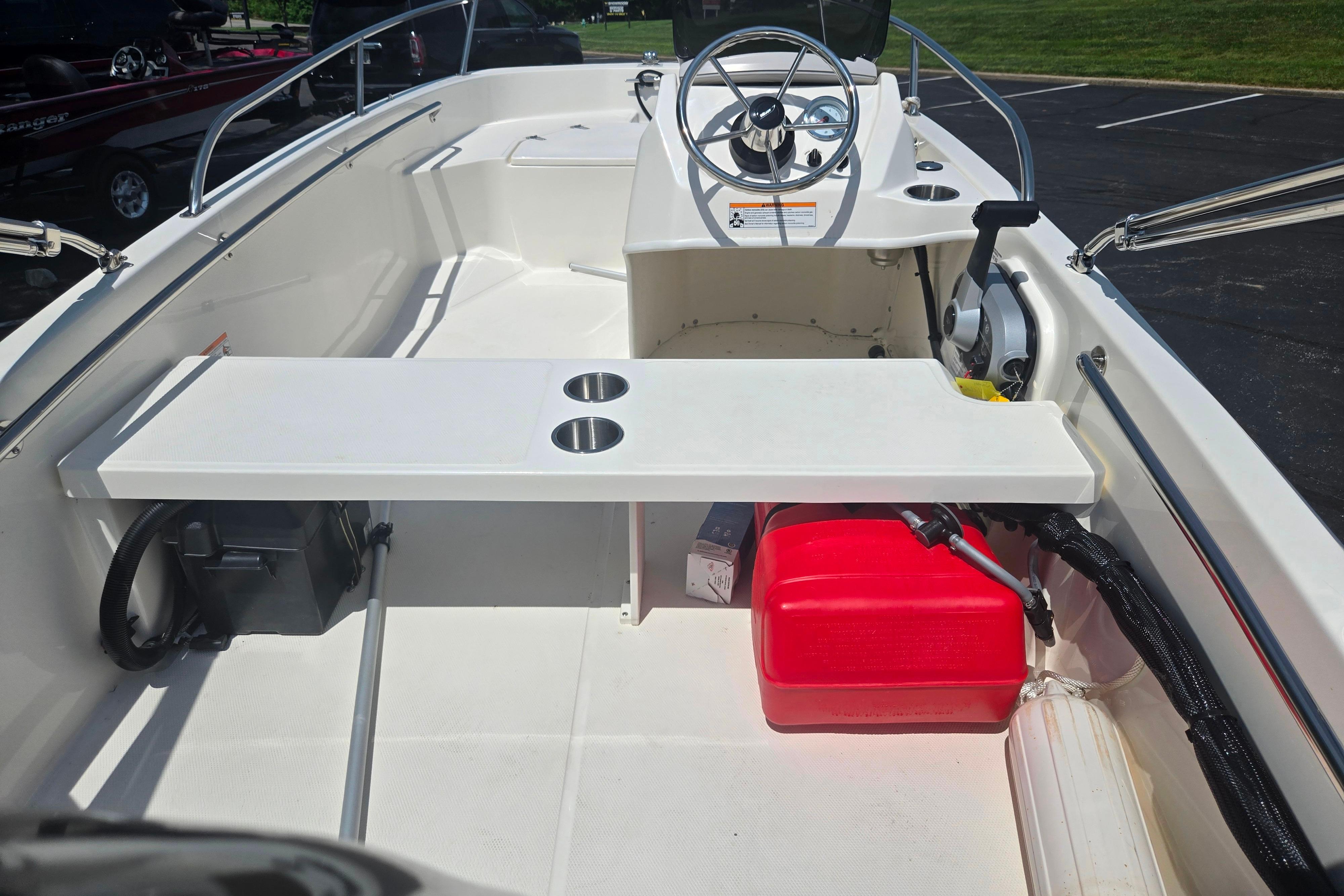 2025 Boston Whaler 130 Super Sport interior with steering wheel and seating area.