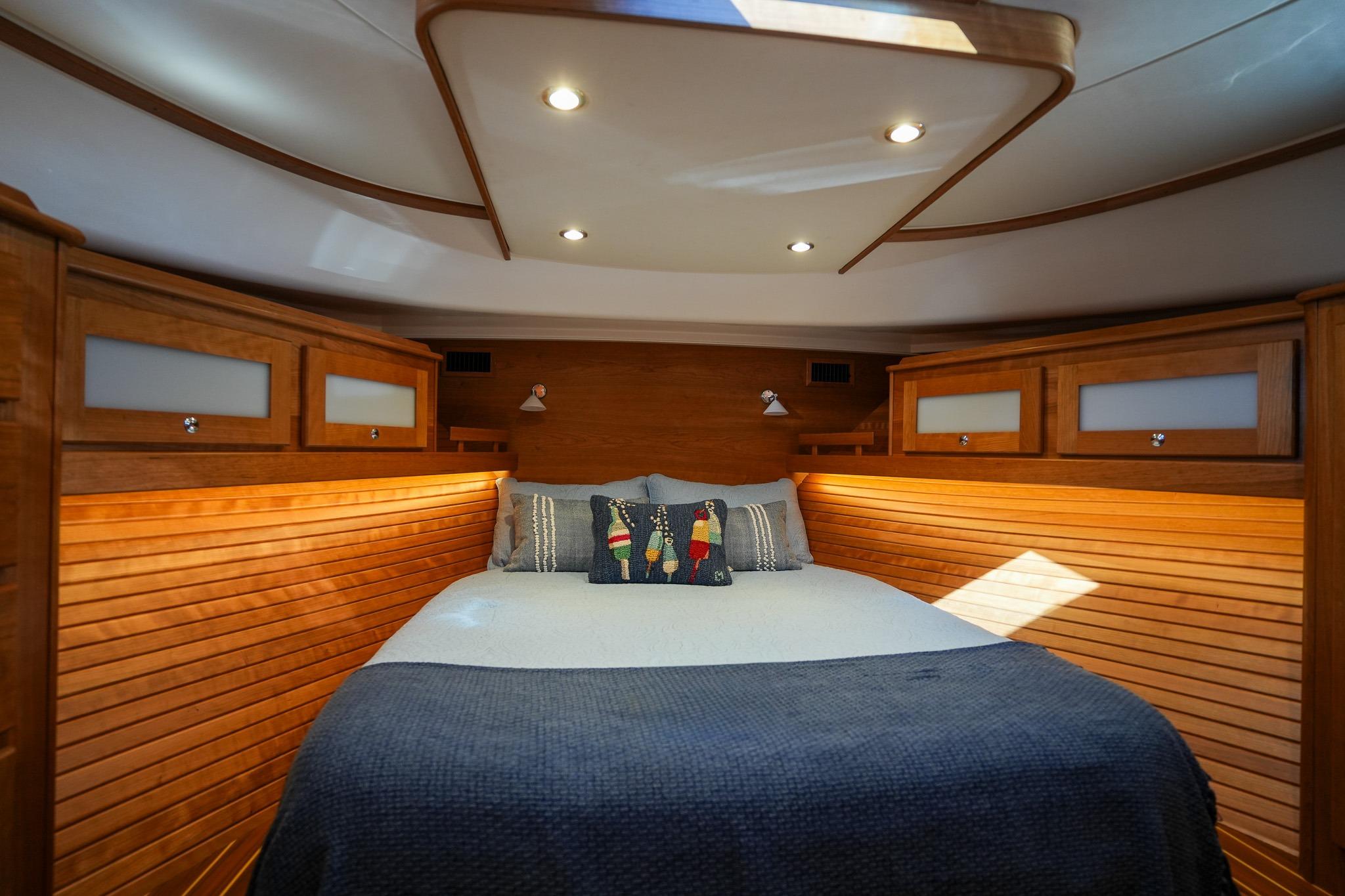 Luxurious cabin interior of 2026 Sabre 51 Salon Express yacht with cozy bedding.