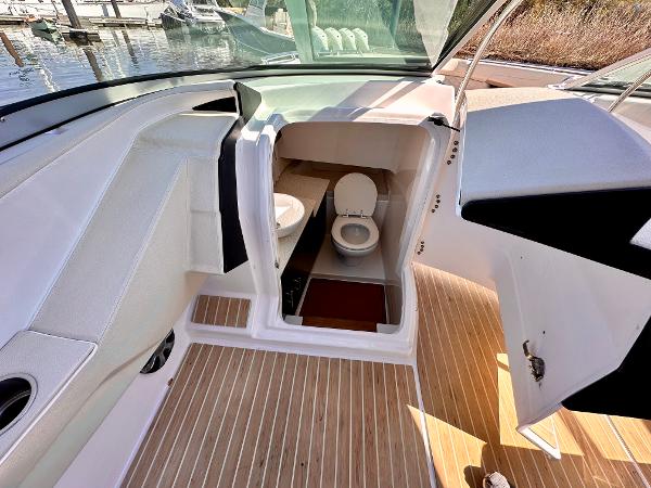 The image shows the cockpit of a 2018 Regal 3300 with access to the toilet.