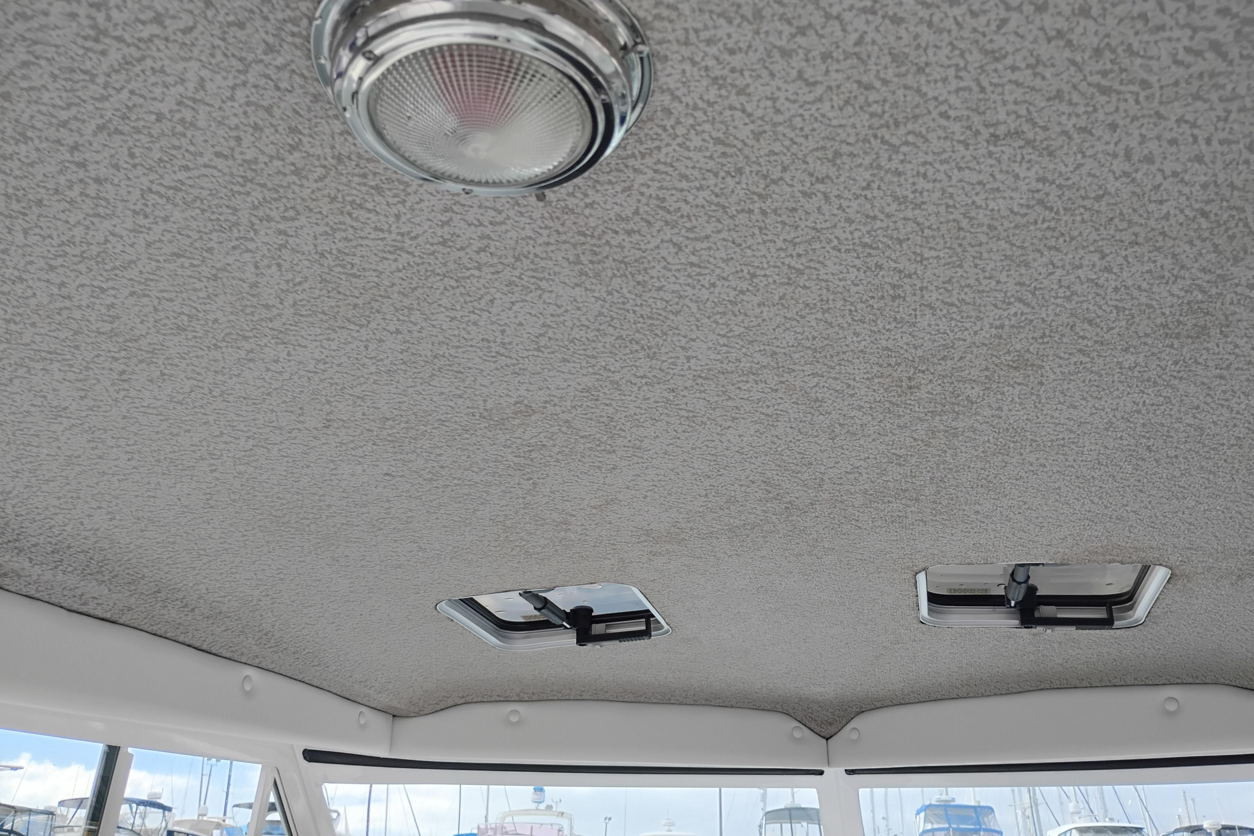 Ceiling view of 2007 Glacier Bay 2685 Coastal Runner boat interior with light fixtures.