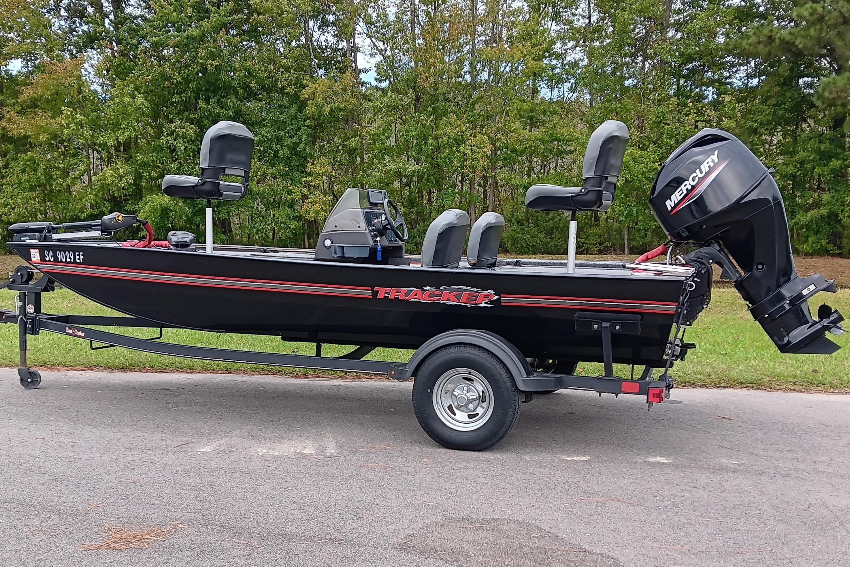 2023 Tracker Bass Tracker Classic XL boat on trailer, parked on road with trees in background.