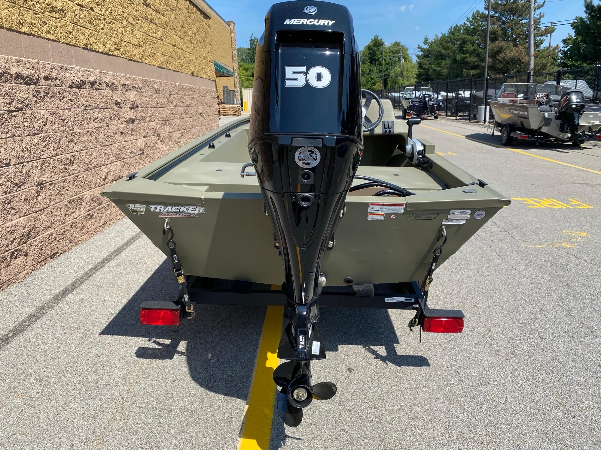 2024 Tracker Grizzly 1648 SC boat with Mercury 50 engine, parked outdoors.