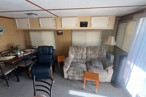 Interior of a 1995 Myacht 40X13 houseboat with cozy seating and dining area.
