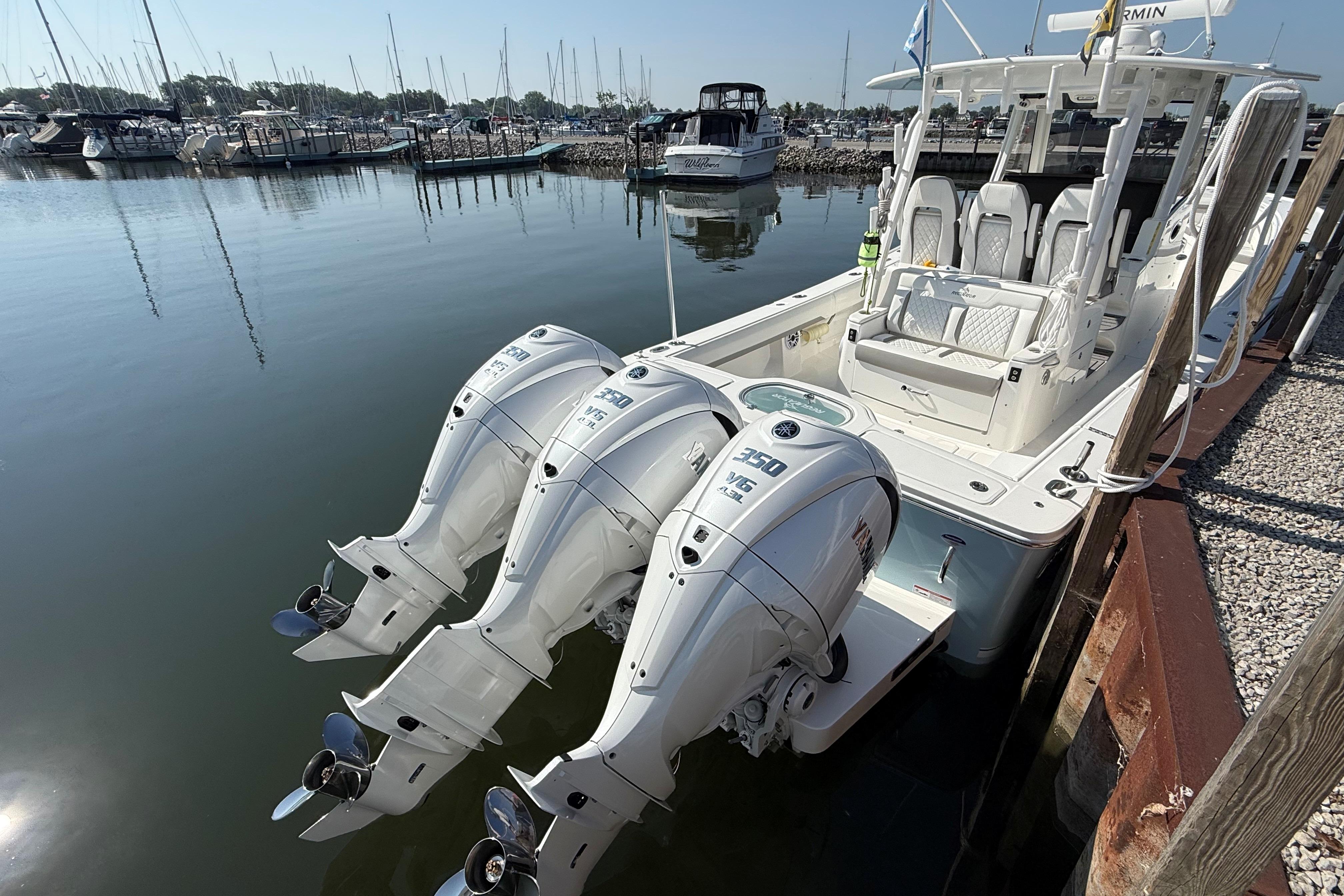2026 Regulator 35 boat with triple outboard engines docked at marina.