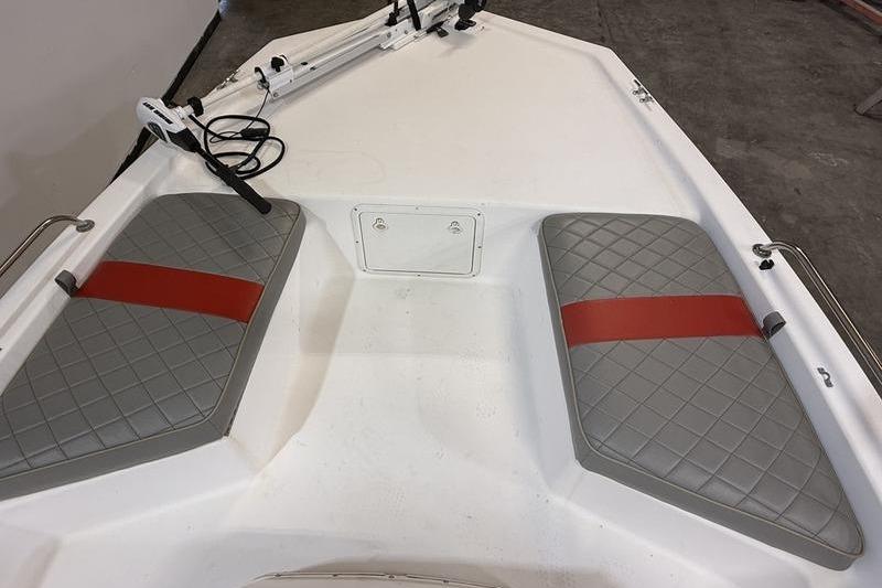 Bow seating area of a 1996 Century 1800 Center Console boat with gray cushions.