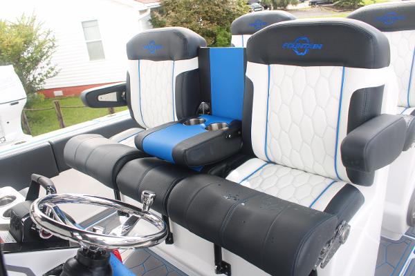 2024 Fountain 34 SC boat interior with luxurious seating and steering wheel.