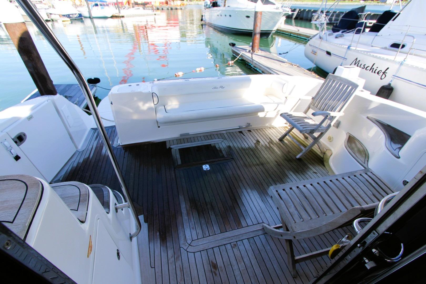 2007 Sea Ray 580 Sedan Bridge yacht deck with seating and wooden flooring.