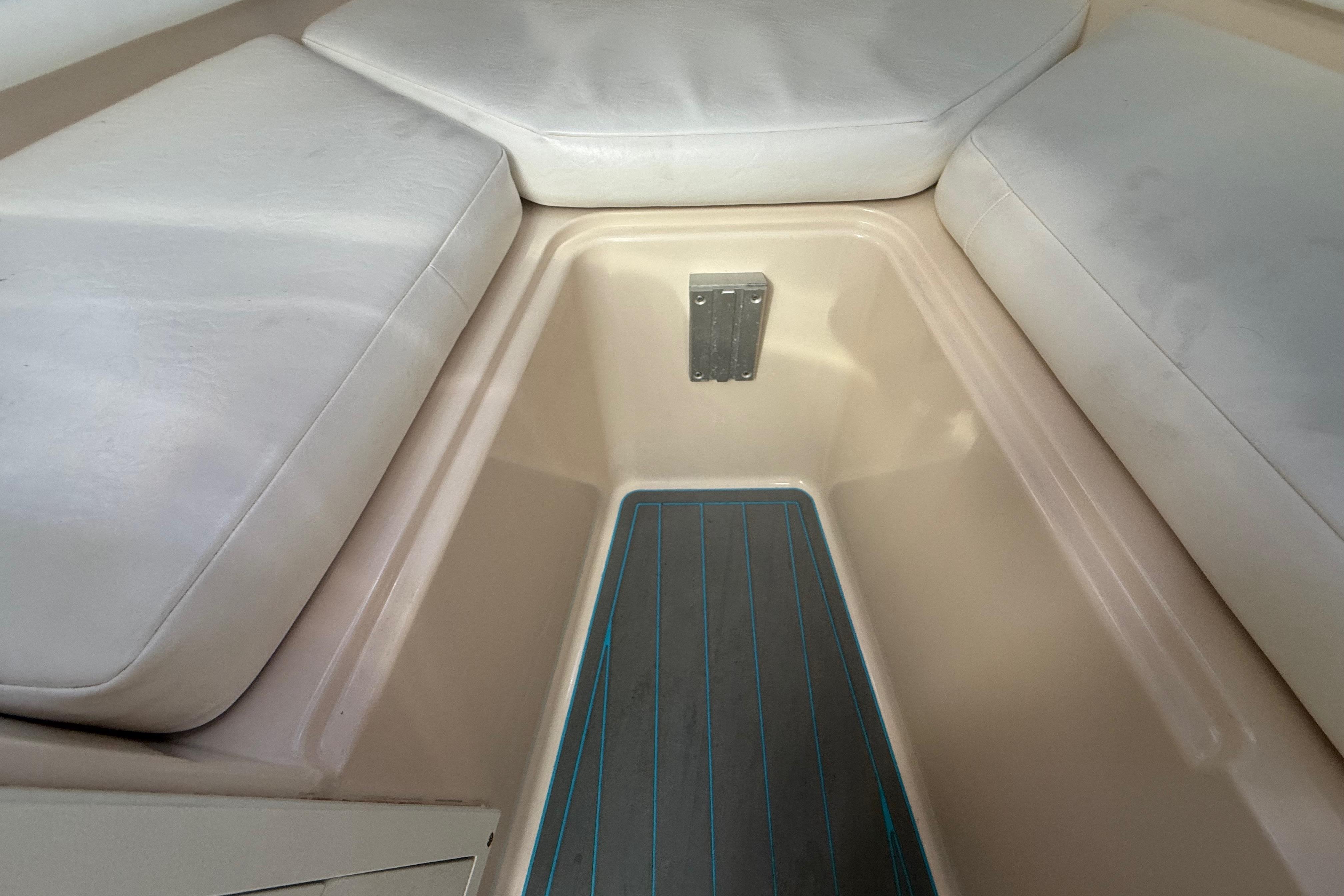 Interior view of a 1996 Grady-White Sailfish 272 boat with cushioned seating.