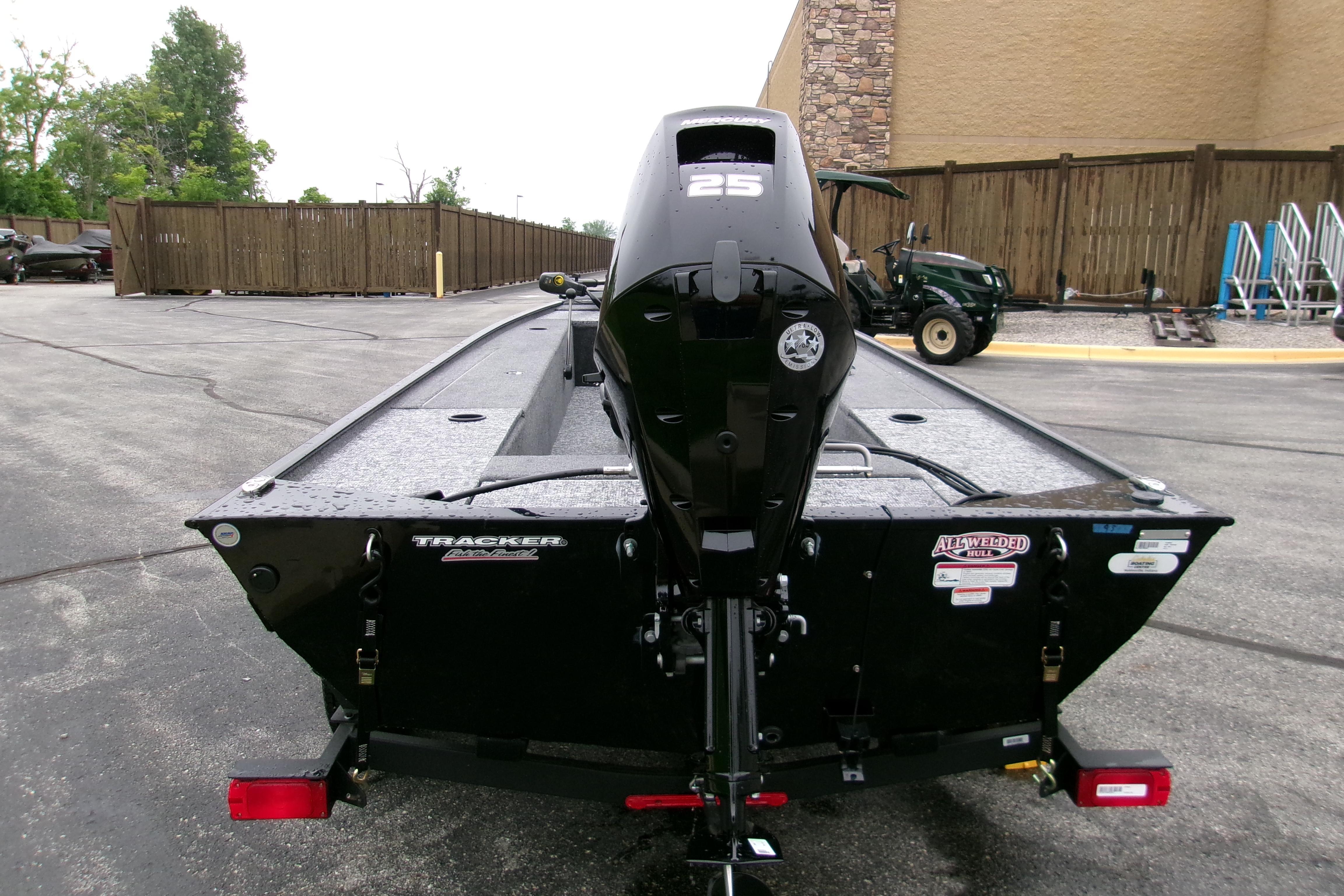 2025 Tracker Panfish 17 boat with 25 HP motor, parked outdoors.