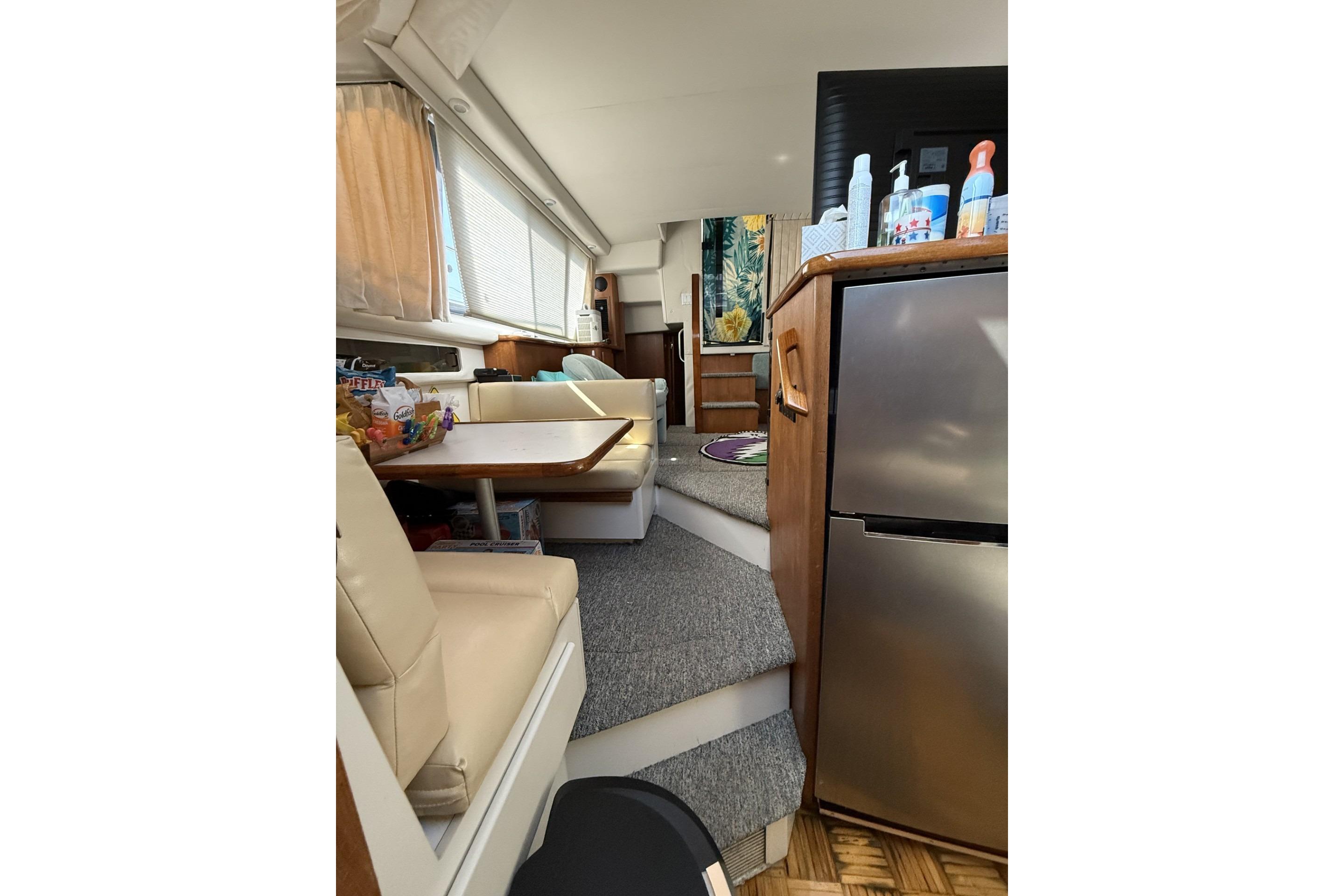Interior of 1993 Carver 350 Motor Yacht with dining area and kitchenette.