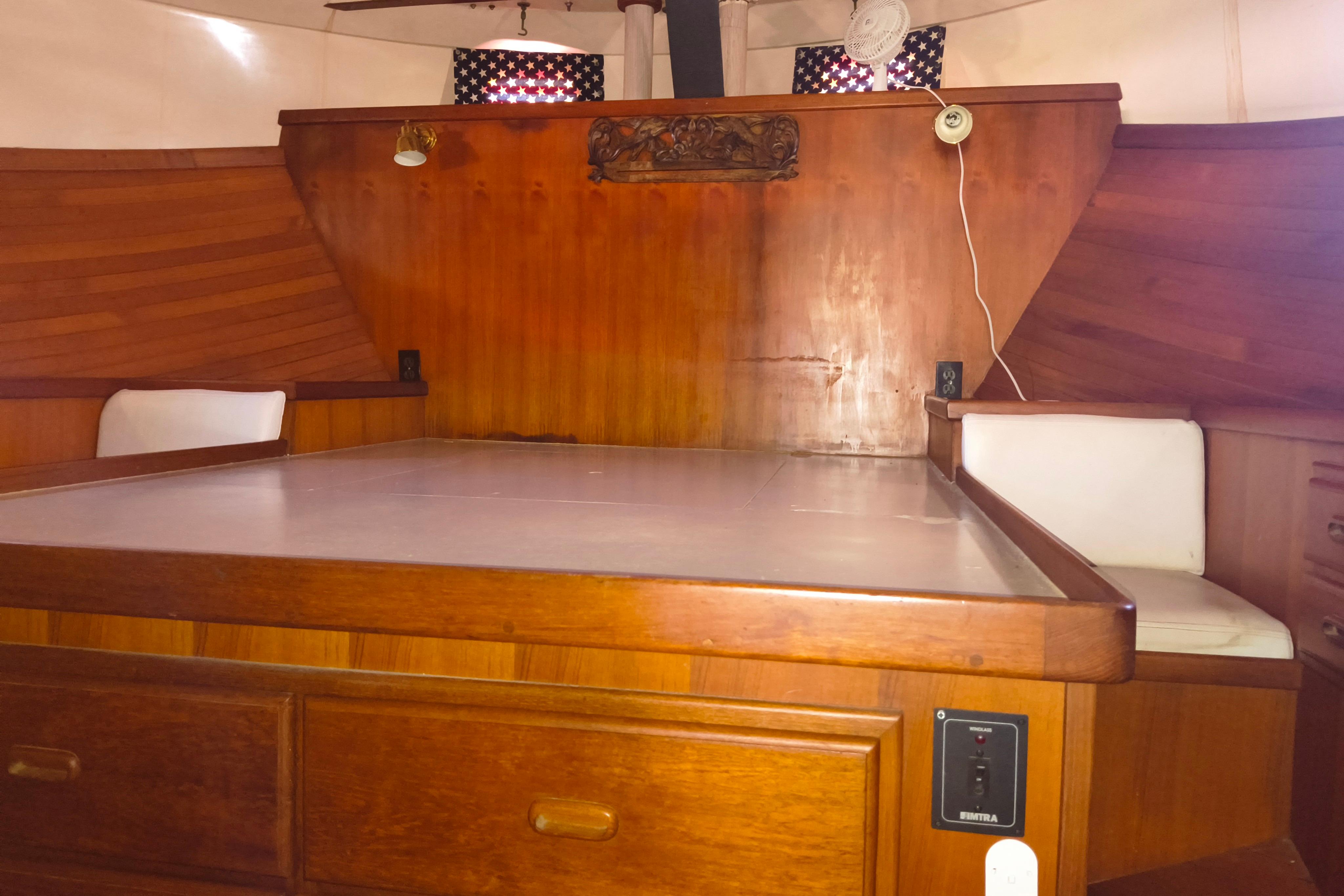 1984 Kadey-Krogen Manatee interior with wooden cabinetry and seating, showcasing classic nautical design.